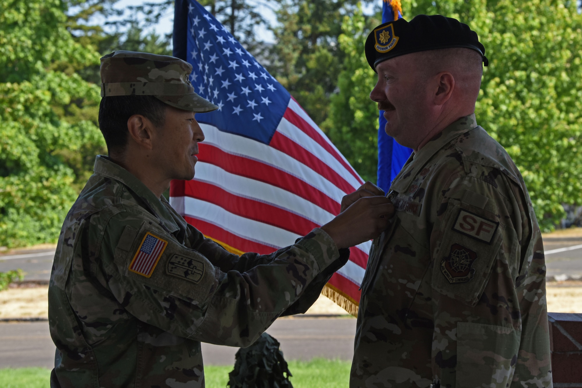 U.S. Army Col. Kent Park, Joint Base Lewis-McChord garrison commander, left, presents Maj. William Morse, outgoing 627th Security Forces commander, with an Army Commendation Medal at the 627th SFS change of command ceremony at Joint Base Lewis-McChord, Washington, July 20, 2023. Morse served as commander of the 627th SFS for two years and under his command, the squadron received the 2022 Air Mobility Command Security Forces Squadron of the Year award. (U.S. Air Force photo by Staff Sgt. Zoe Thacker)