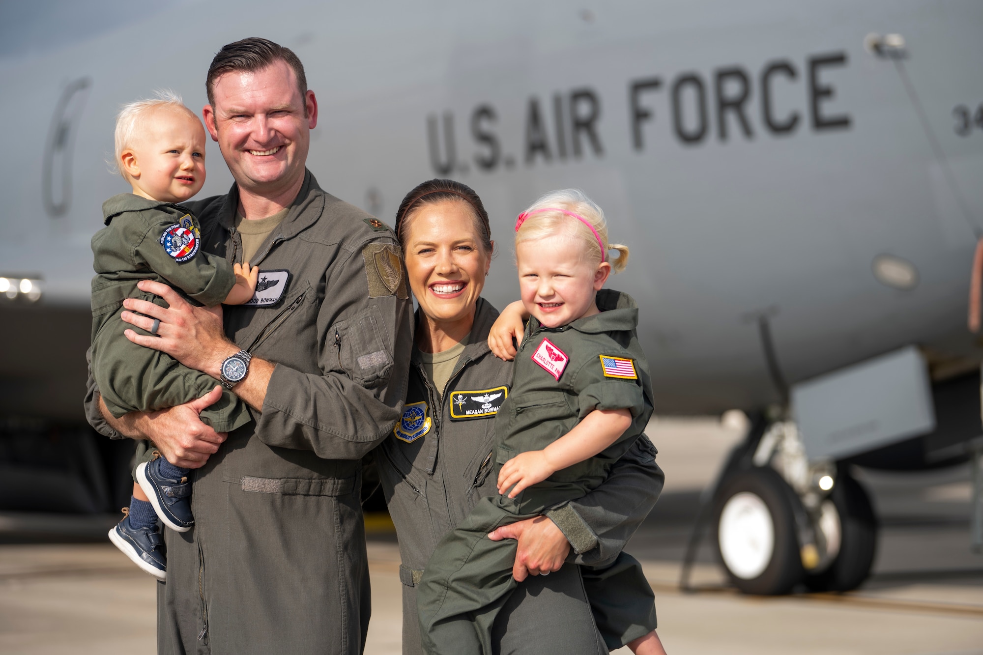 The Bowman family poses for a photo on the flight line at MacDill Air Force Base, Florida, July 18, 2023. U.S. Air Force Maj. Meagan Bowman, assistant director of operations and evaluator pilot for the KC-135 Stratotanker with the 91st Air Refueling Squadron, and her husband, Maj. Woody Bowman, joint operational planner at U.S. Central Command, exemplify the true meaning of love, sacrifice and resiliency as they navigate the challenges of parenthood, their dedication to each other and their military careers. (U.S. Air Force photo by Senior Airman Lauren Cobin)