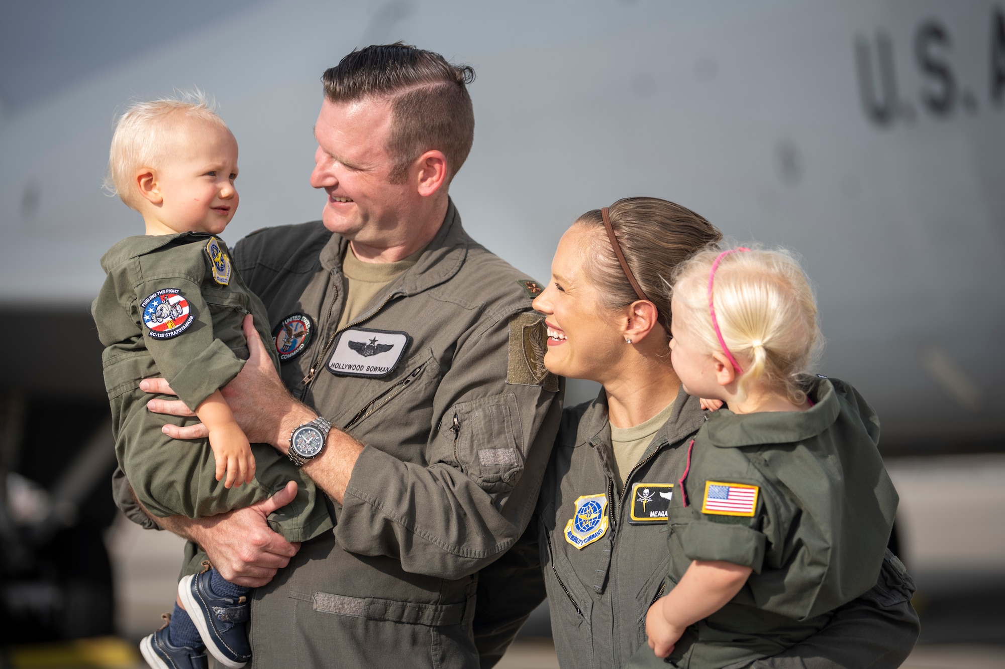 The Bowman family poses for a photo on the flight line at MacDill Air Force Base, Florida, July 18, 2023. U.S. Air Force Maj. Meagan Bowman, assistant director of operations and evaluator pilot for the KC-135 Stratotanker with the 91st Air Refueling Squadron, and her husband, Maj. Woody Bowman, joint operational planner at U.S. Central Command, exemplify the true meaning of love, sacrifice and resiliency as they navigate the challenges of parenthood, their dedication to each other and their military careers. (U.S. Air Force photo by Senior Airman Lauren Cobin)