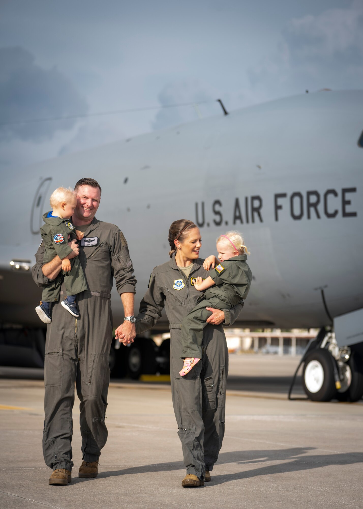 The Bowman family poses for a photo on the flight line at MacDill Air Force Base, Florida, July 18, 2023. U.S. Air Force Maj. Meagan Bowman, assistant director of operations and evaluator pilot for the KC-135 Stratotanker with the 91st Air Refueling Squadron, and her husband, Maj. Woody Bowman, joint operational planner at U.S. Central Command, exemplify the true meaning of love, sacrifice and resiliency as they navigate the challenges of parenthood, their dedication to each other and their military careers. (U.S. Air Force photo by Senior Airman Lauren Cobin)