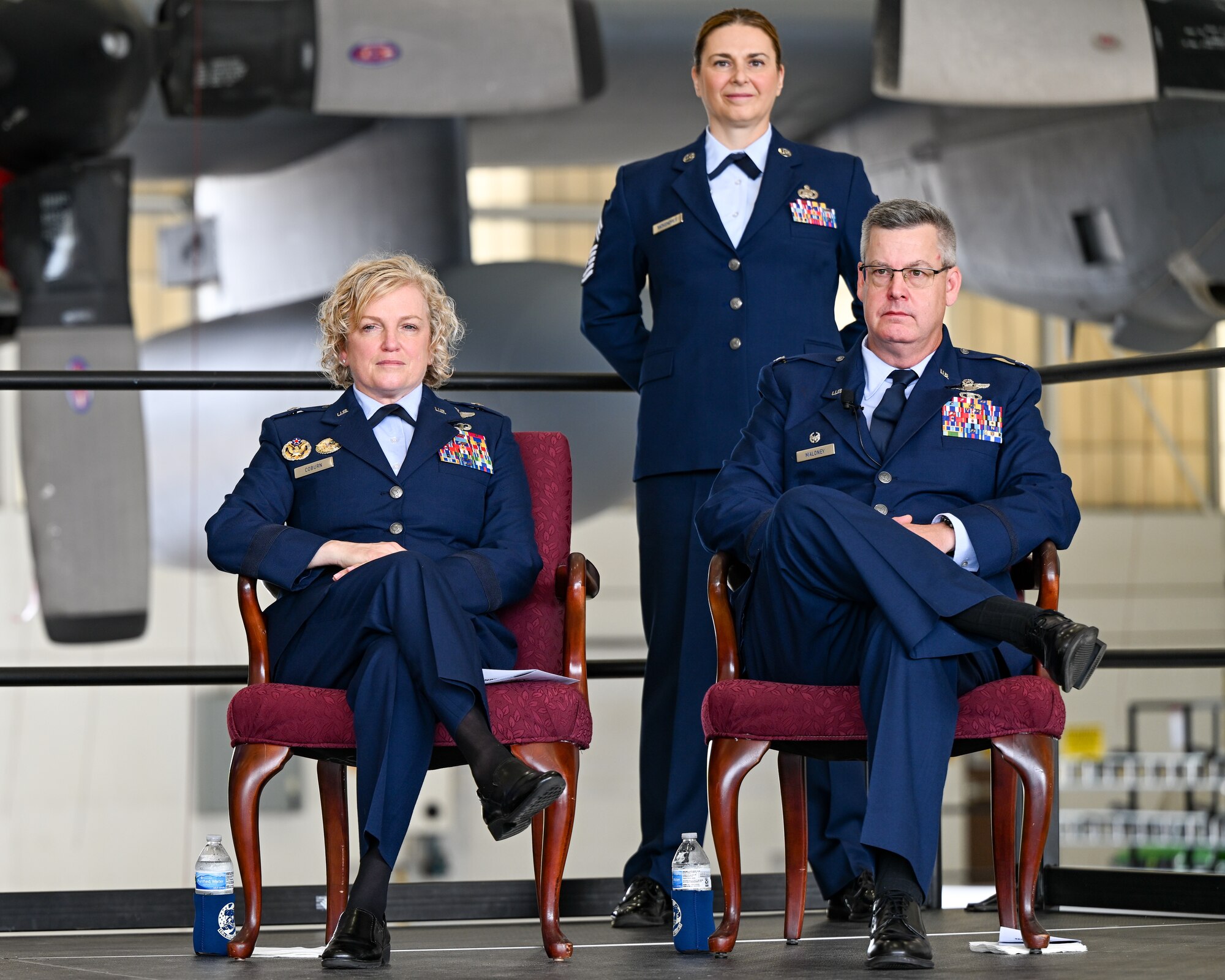 Brig. Gen. Melissa Coburn, 22nd Air Force commander, Chief Master Sgt. Jennifer McKendree, 910th Airlift Wing command chief, and Col. Michael Maloney, 910th Airlift Wing commander, face the audience at the beginning of the wing assumption of command ceremony, July 15, 2023, at Youngstown Air Reserve Station, Ohio.