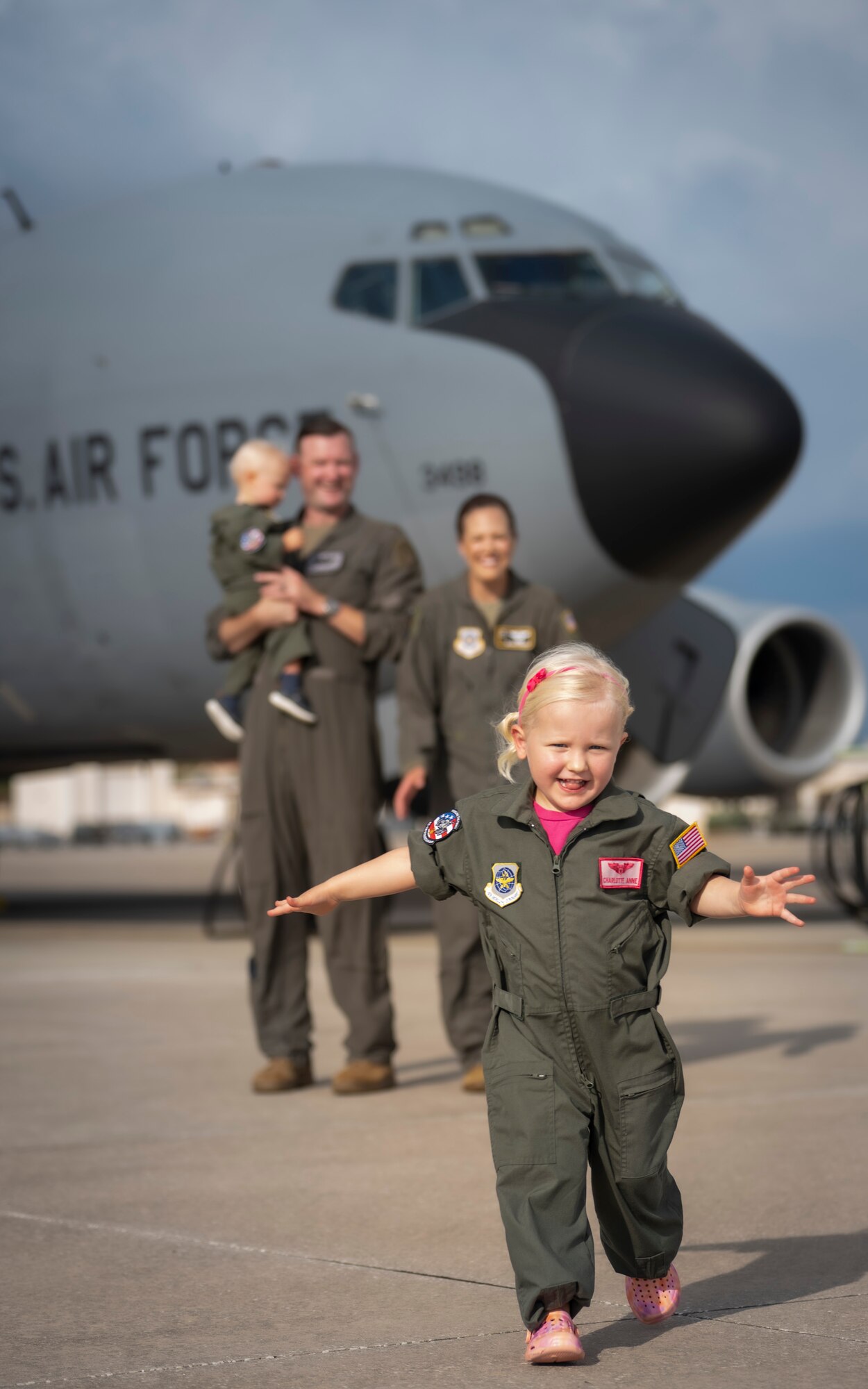 The Bowman family poses for a photo on the flight line at MacDill Air Force Base, Florida, July 18, 2023. U.S. Air Force Maj. Meagan Bowman, assistant director of operations and evaluator pilot for the KC-135 Stratotanker with the 91st Air Refueling Squadron, and her husband, Maj. Woody Bowman, joint operational planner at U.S. Central Command, exemplify the true meaning of love, sacrifice and resiliency as they navigate the challenges of parenthood, their dedication to each other and their military careers. (U.S. Air Force photo by Senior Airman Lauren Cobin)