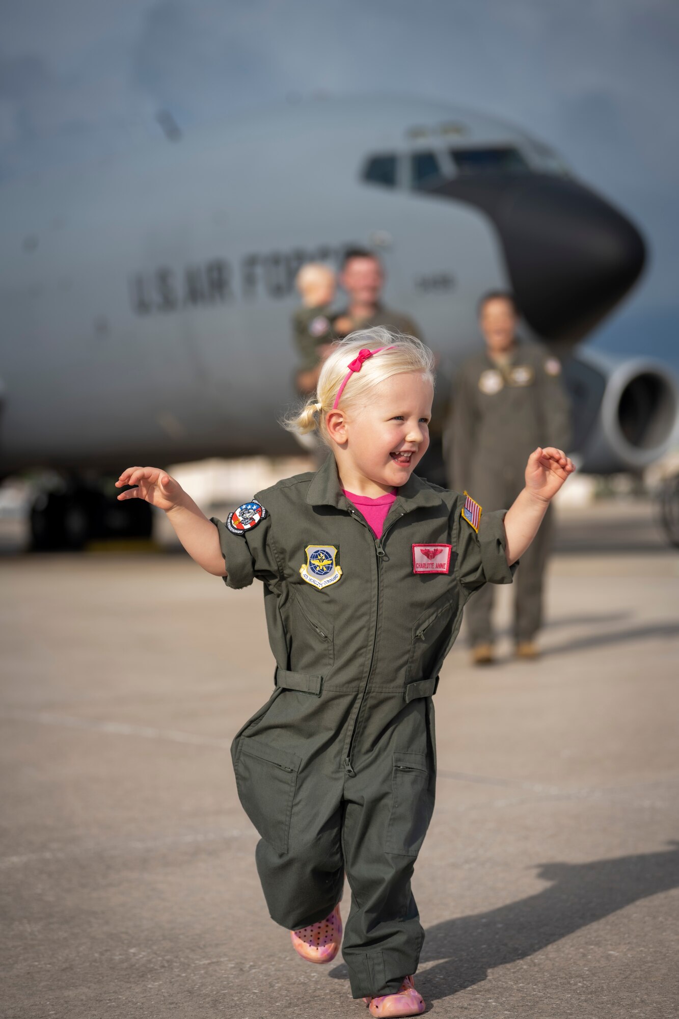 The Bowman family poses for a photo on the flight line at MacDill Air Force Base, Florida, July 18, 2023. U.S. Air Force Maj. Meagan Bowman, assistant director of operations and evaluator pilot for the KC-135 Stratotanker with the 91st Air Refueling Squadron, and her husband, Maj. Woody Bowman, joint operational planner at U.S. Central Command, exemplify the true meaning of love, sacrifice and resiliency as they navigate the challenges of parenthood, their dedication to each other and their military careers. (U.S. Air Force photo by Senior Airman Lauren Cobin)