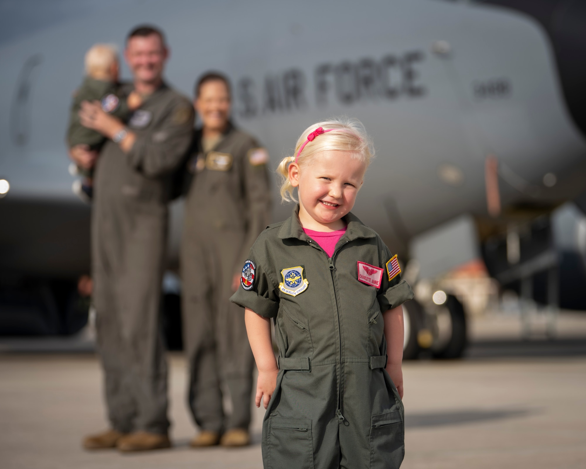 The Bowman family poses for a photo on the flight line at MacDill Air Force Base, Florida, July 18, 2023. U.S. Air Force Maj. Meagan Bowman, assistant director of operations and evaluator pilot for the KC-135 Stratotanker with the 91st Air Refueling Squadron, and her husband, Maj. Woody Bowman, joint operational planner at U.S. Central Command, exemplify the true meaning of love, sacrifice and resiliency as they navigate the challenges of parenthood, their dedication to each other and their military careers. (U.S. Air Force photo by Senior Airman Lauren Cobin)