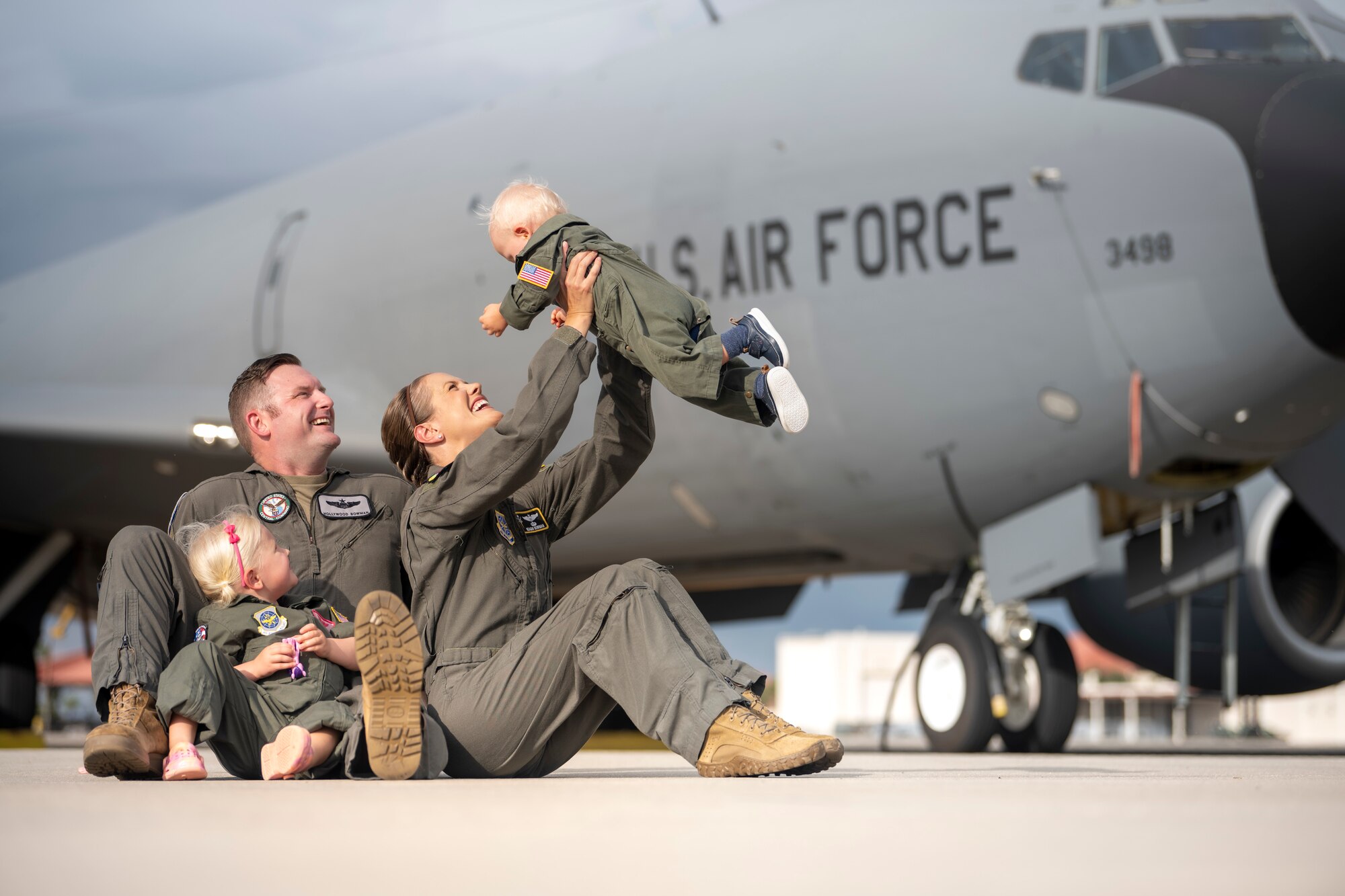 The Bowman family poses for a photo on the flight line at MacDill Air Force Base, Florida, July 18, 2023. U.S. Air Force Maj. Meagan Bowman, assistant director of operations and evaluator pilot for the KC-135 Stratotanker with the 91st Air Refueling Squadron, and her husband, Maj. Woody Bowman, joint operational planner at U.S. Central Command, exemplify the true meaning of love, sacrifice and resiliency as they navigate the challenges of parenthood, their dedication to each other and their military careers. (U.S. Air Force photo by Senior Airman Lauren Cobin)