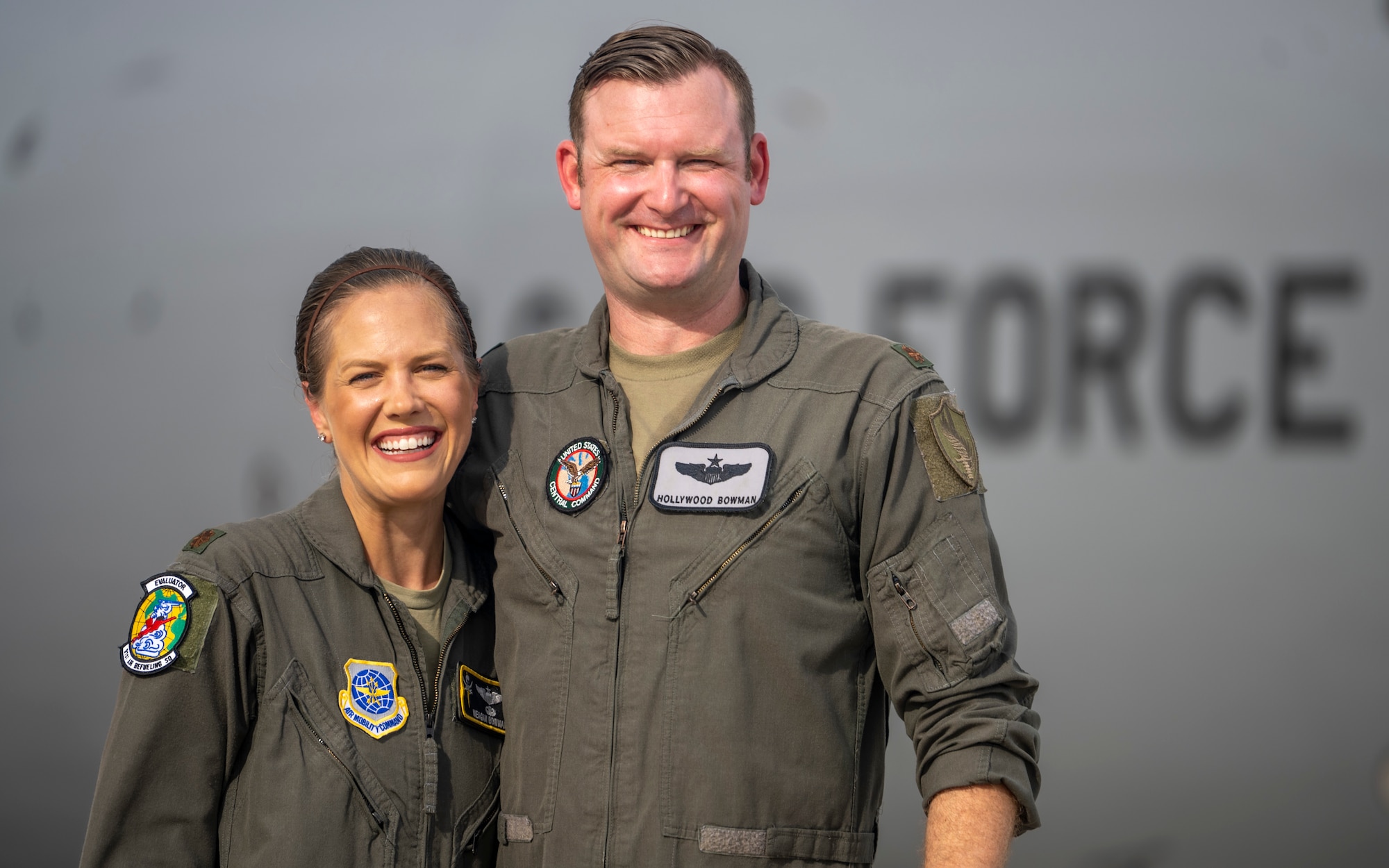 U.S. Air Force Maj. Meagan Bowman, assistant director of operations and evaluator pilot for the KC-135 Stratotanker with the 91st Air Refueling Squadron, and her husband, Maj. Woody Bowman, joint operational planner at U.S. Central Command, poses for a photo on the flight line at MacDill Air Force Base, Florida, July 18, 2023. This dual military couple exemplify the true meaning of love, sacrifice and resiliency as they navigate the challenges of parenthood, their dedication to each other and their military careers. (U.S. Air Force photo by Senior Airman Lauren Cobin)