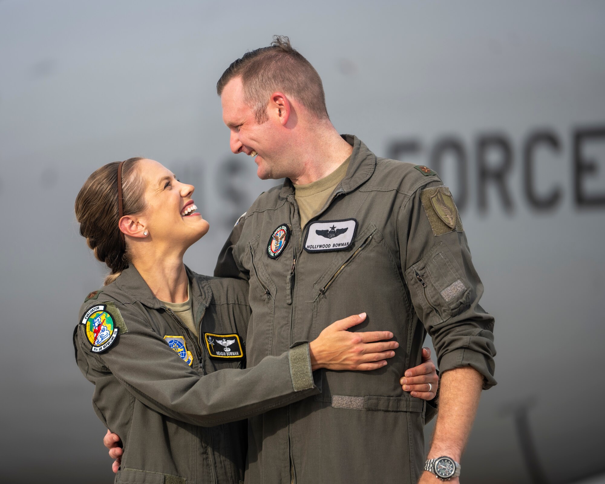 U.S. Air Force Maj. Meagan Bowman, assistant director of operations and evaluator pilot for the KC-135 Stratotanker with the 91st Air Refueling Squadron, and her husband, Maj. Woody Bowman, joint operational planner at U.S. Central Command, poses for a photo on the flight line at MacDill Air Force Base, Florida, July 18, 2023. This dual military couple exemplify the true meaning of love, sacrifice and resiliency as they navigate the challenges of parenthood, their dedication to each other and their military careers. (U.S. Air Force photo by Senior Airman Lauren Cobin)