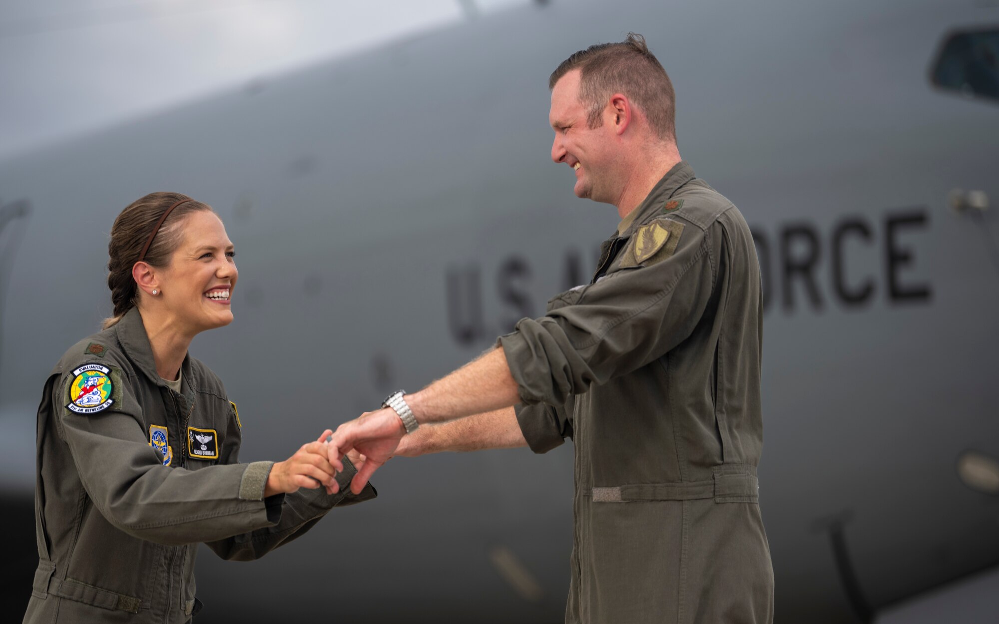 U.S. Air Force Maj. Meagan Bowman, assistant director of operations and evaluator pilot for the KC-135 Stratotanker with the 91st Air Refueling Squadron, and her husband, Maj. Woody Bowman, joint operational planner at U.S. Central Command, poses for a photo on the flight line at MacDill Air Force Base, Florida, July 18, 2023. This dual military couple exemplify the true meaning of love, sacrifice and resiliency as they navigate the challenges of parenthood, their dedication to each other and their military careers. (U.S. Air Force photo by Senior Airman Lauren Cobin)