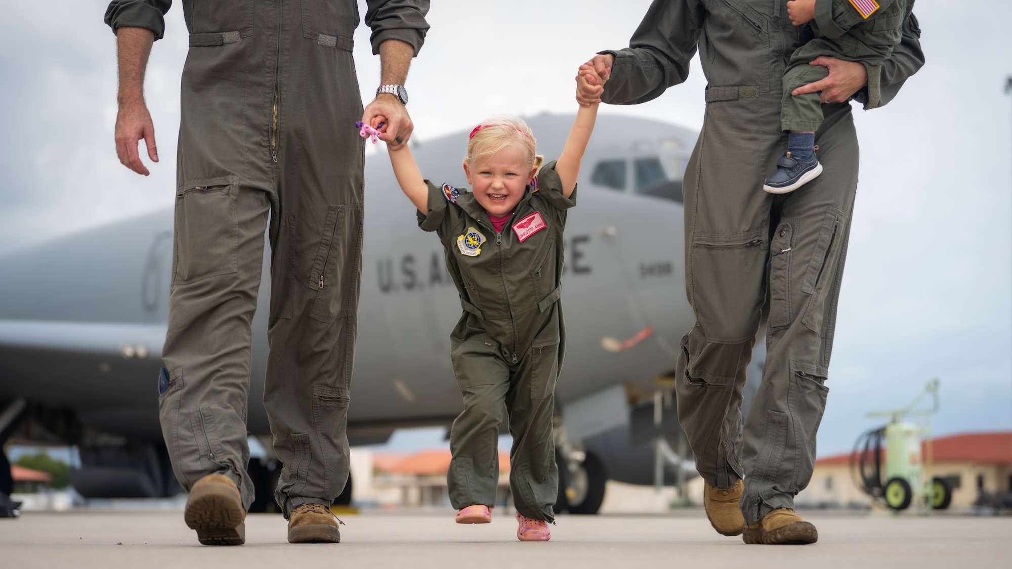 The Bowman family poses for a photo on the flight line at MacDill Air Force Base, Florida, July 18, 2023. U.S. Air Force Maj. Meagan Bowman, assistant director of operations and evaluator pilot for the KC-135 Stratotanker with the 91st Air Refueling Squadron, and her husband, Maj. Woody Bowman, joint operational planner at U.S. Central Command, exemplify the true meaning of love, sacrifice and resiliency as they navigate the challenges of parenthood, their dedication to each other and their military careers. (U.S. Air Force photo by Senior Airman Lauren Cobin)