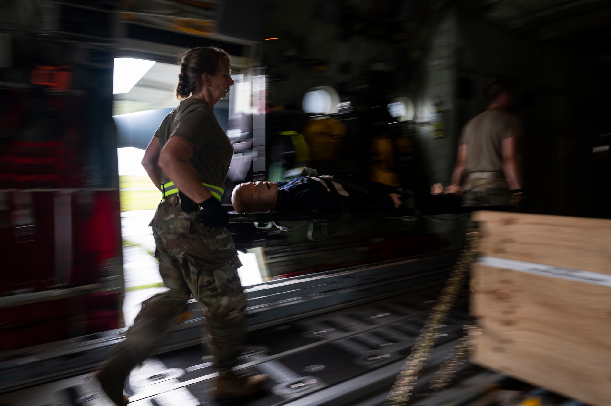 U.S. Air Force aeromedical evacuation Airmen transport a simulated patient onto a Royal Australian Air Force C-130J-30 Super Hercules during Mobility Guardian 23 at Andersen Air Force Base, Guam, July 13, 2023. A multilateral endeavor, MG23 features seven participating countries - Australia, Canada, France, Japan, New Zealand, United Kingdom, and the United States - opening approximately 70 mobility aircraft across multiple locations spanning a 3,000-mile exercise area from July 5 through July 21. (U.S. Air Force photo by Tech. Sgt. Joseph Pick)