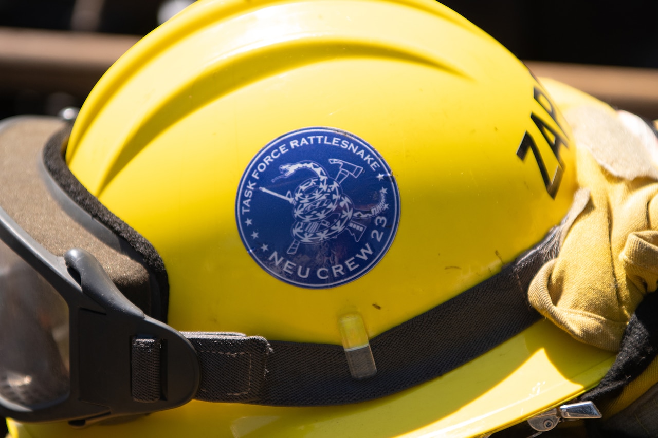 A helmet bears a seal with the words Task Force Rattlesnake.