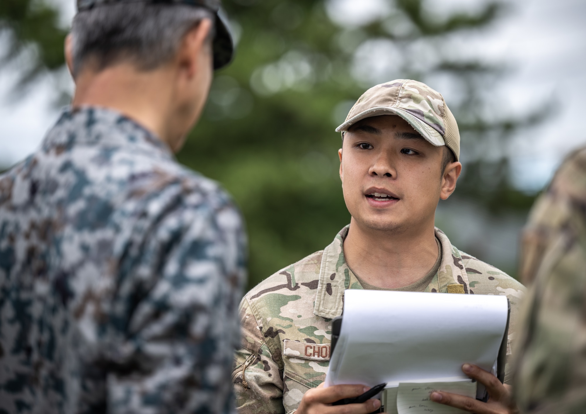 U.S. Air Force Senior Airman Kelvin Chong, a Japanese translator assigned to the 18th Security Forces Squadron, speaks to Lt. Gen. Ryusuke Morikawa, commander of Air Support Command in support of Mobility Guardian 2023, at Yakumo Sub Base, Japan, July 13, 2023. During MG23, Chong served as the strategic cultural representative for the Japanese Air Self-Defense Force and U.S. Air Force, ensuring accurate and efficient communication among partner nations. A multilateral endeavor, MG23 features participating countries – Australia, Canada, France, Japan, New Zealand, United Kingdom, and the United States – operating approximately 70 mobility aircraft across multiple locations spanning a 3,000 mile exercise area from July 5-21. (U.S. Air Force photo by Tech. Sgt. Alexander Cook