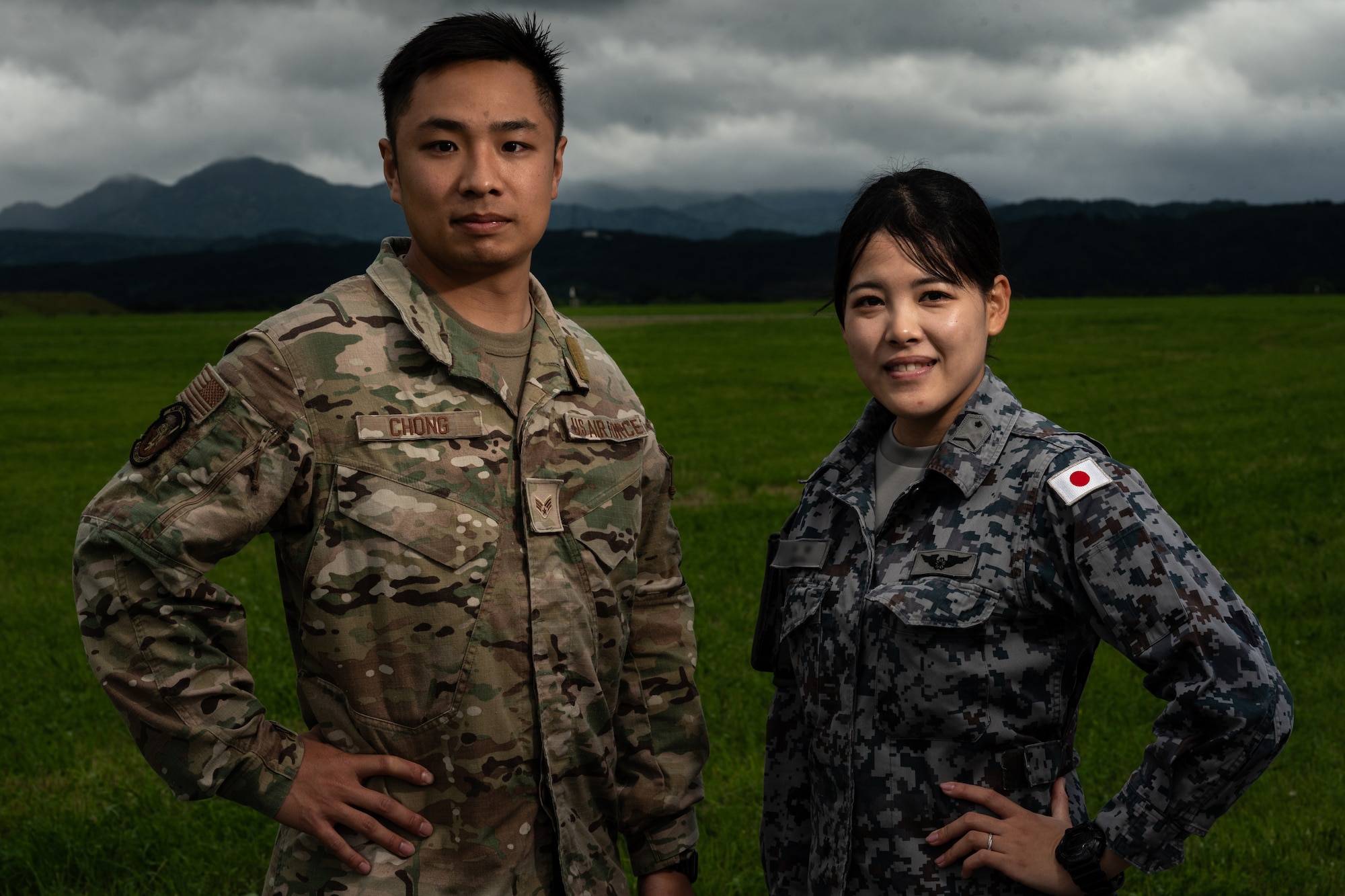 U.S. Air Force Senior Airman Kelvin Chong, left, 18th Security Forces Squadron Japanese translator, and Japan Air Self-Defense Force Staff Sgt. Hinata Misora, poses for a portrait in support of Mobility Guardian 2023, at Yakumo Sub Base, Japan, July 13, 2023. During MG23, Chong and Misora served as the strategic cultural representative for the Japanese Air Self-Defense Force and U.S. Air Force ensuring accurate and efficient communication among partner nations. A multilateral endeavor, MG23 features participating countries – Australia, Canada, France, Japan, New Zealand, United Kingdom, and the United States – operating approximately 70 mobility aircraft across multiple locations spanning a 3,000 mile exercise area from July 5-21 (U.S. Air Force photo by Tech. Sgt. Alexander Cook)