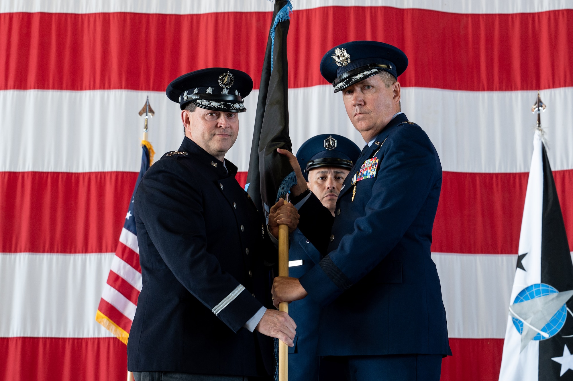 U.S. Air Force Maj. Gen. Shawn N. Bratton, Space Training and Readiness Command (STARCOM) outgoing commander, right, presents the unit guidon to Chief of Space Operations, Gen. Chance Saltzman, during STARCOM’s change of command ceremony at Peterson Space Force Base, Colorado, July 20, 2023. Bratton relinquished command to U.S. Space Force Brig. Gen. Timothy A. Sejba during the ceremony. (U.S. Space Force photo by Ethan Johnson)