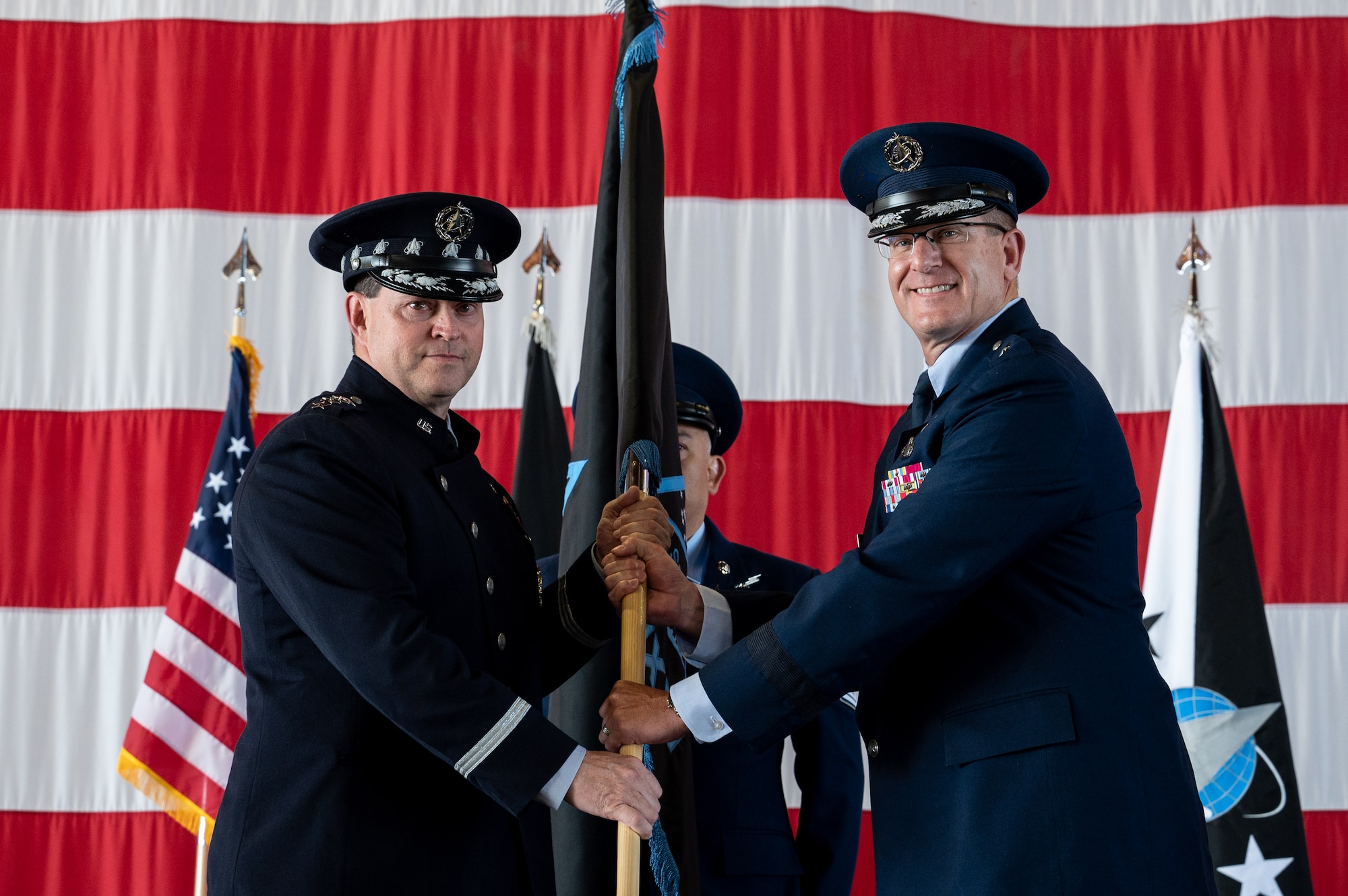 U.S. Space Force Brig. Gen. Timothy A. Sejba, Space Training and Readiness Command (STARCOM) incoming commander, right, accepts the unit guidon from Chief of Space Operations, Gen. Chance Saltzman, during STARCOM’s change of command ceremony at Peterson Space Force Base, Colorado, July 20, 2023. Sejba assumed command from U.S. Air Force Maj. Gen. Shawn N. Bratton during the ceremony. (U.S. Space Force photo by Ethan Johnson)
