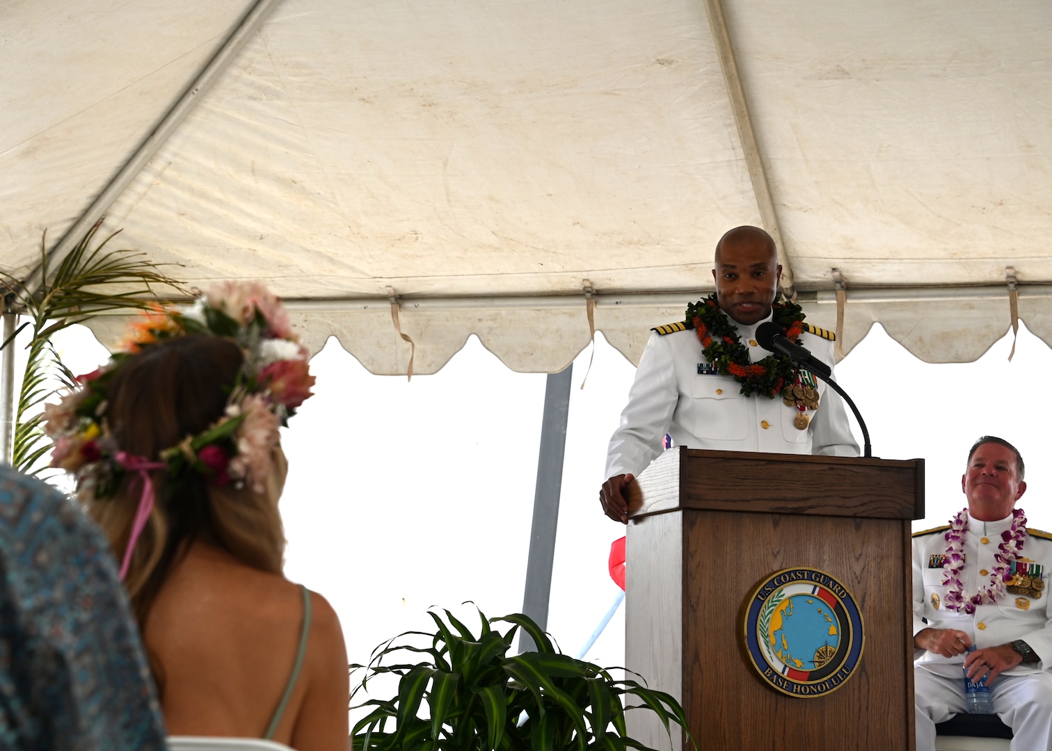 Capt. Willie Carmichael thanks his wife during the U.S. Coast Guard Cutter Midgett’s (WMSL 757) change of command ceremony on Coast Guard Base Honolulu, July 20, 2023. Rear Adm. Brendan C. McPherson (left), deputy commander of U.S. Coast Guard Pacific Area, presided over the ceremony in which Capt. Matthew Rooney relieved Carmichael as Midgett’s commanding officer. U.S. Coast Guard photo by Chief Petty Officer Matthew Masaschi.