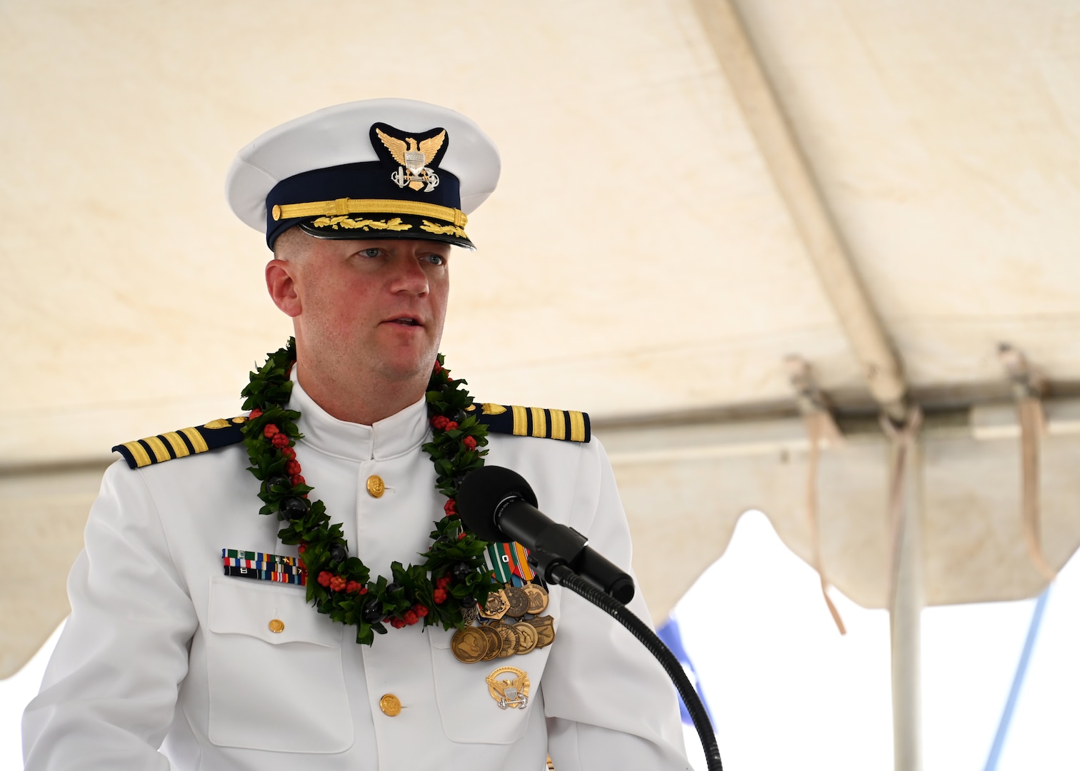 Capt. Matthew Rooney speaks during the U.S. Coast Guard Cutter Midgett’s (WMSL 757) change of command ceremony on Coast Guard Base Honolulu, July 20, 2023. Rear Adm. Brendan C. McPherson, deputy commander of U.S. Coast Guard Pacific Area, presided over the ceremony in which Rooney relieved Capt. Willie Carmichael as Midgett’s commanding officer. U.S. Coast Guard photo by Chief Petty Officer Matthew Masaschi.