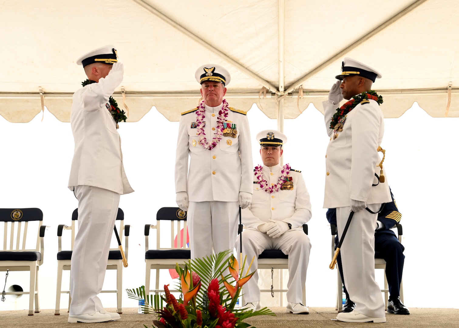 Capt. Matthew Rooney (left) salutes Capt. Willie Carmichael (right) during the U.S. Coast Guard Cutter Midgett’s (WMSL 757) change of command ceremony on Coast Guard Base Honolulu, July 20, 2023. Rear Adm. Brendan C. McPherson (center), deputy commander of U.S. Coast Guard Pacific Area, presided over the ceremony in which Rooney relieved Carmichael as Midgett’s commanding officer. U.S. Coast Guard photo by Chief Petty Officer Matthew Masaschi.