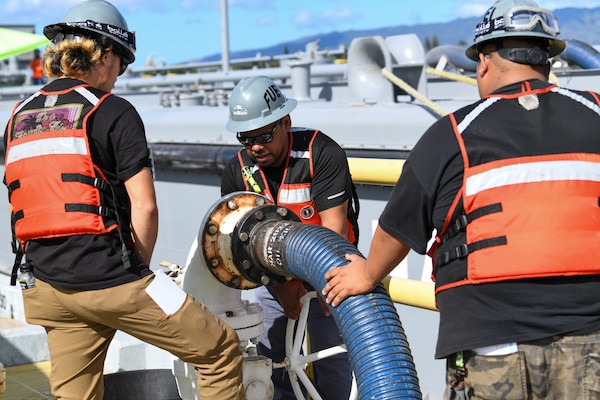 Naval Supply Systems Command Fleet Logistics Center Pearl Harbor fuel distribution system workers turn a valve to begin unpacking F76 marine diesel fuel during an unpacking operation onboard Joint Base Pearl Harbor-Hickam (JBPHH), Hawaii, Oct. 27, 2022. The unpacking operation will remove approximately one million gallons of fuel from three primary fuel pipelines connecting the Red Hill Bulk Fuel Storage Facility (RHBFSF) to fuel points on JBPHH. JTF-RH was established by the Department of Defense to ensure the safe and expeditious defueling of the RHBFSF. (U.S. Marine Corps photo by Cpl. Luke Cohen)