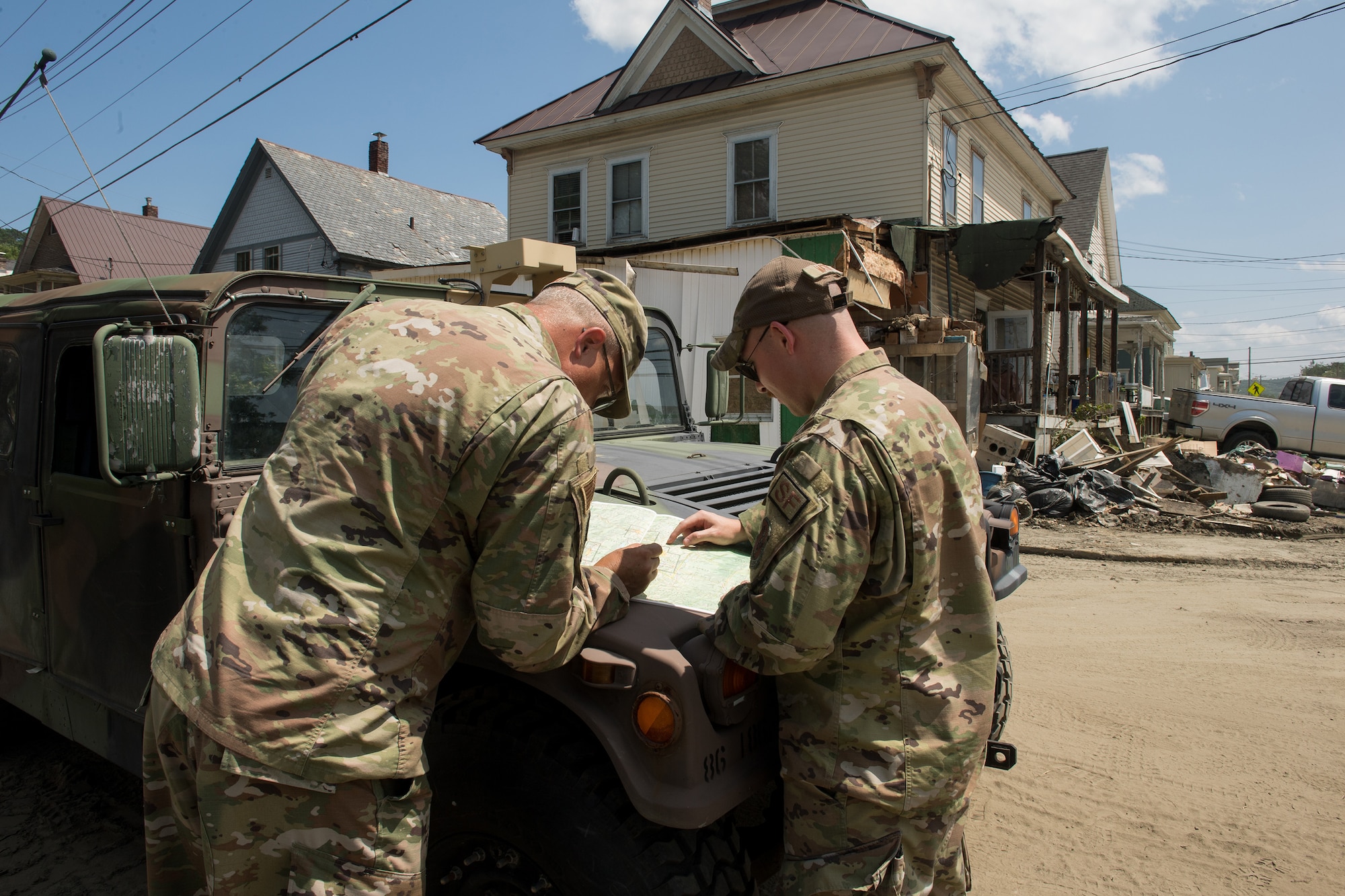 Senior Master Sgt. Matthew Powell (left), 158th Cyber Operations superintendent, and Tech. Sgt. Brandon Matott, 158th Security Forces Squadron personnel, survey a map as part of a Liaison Officer Mission