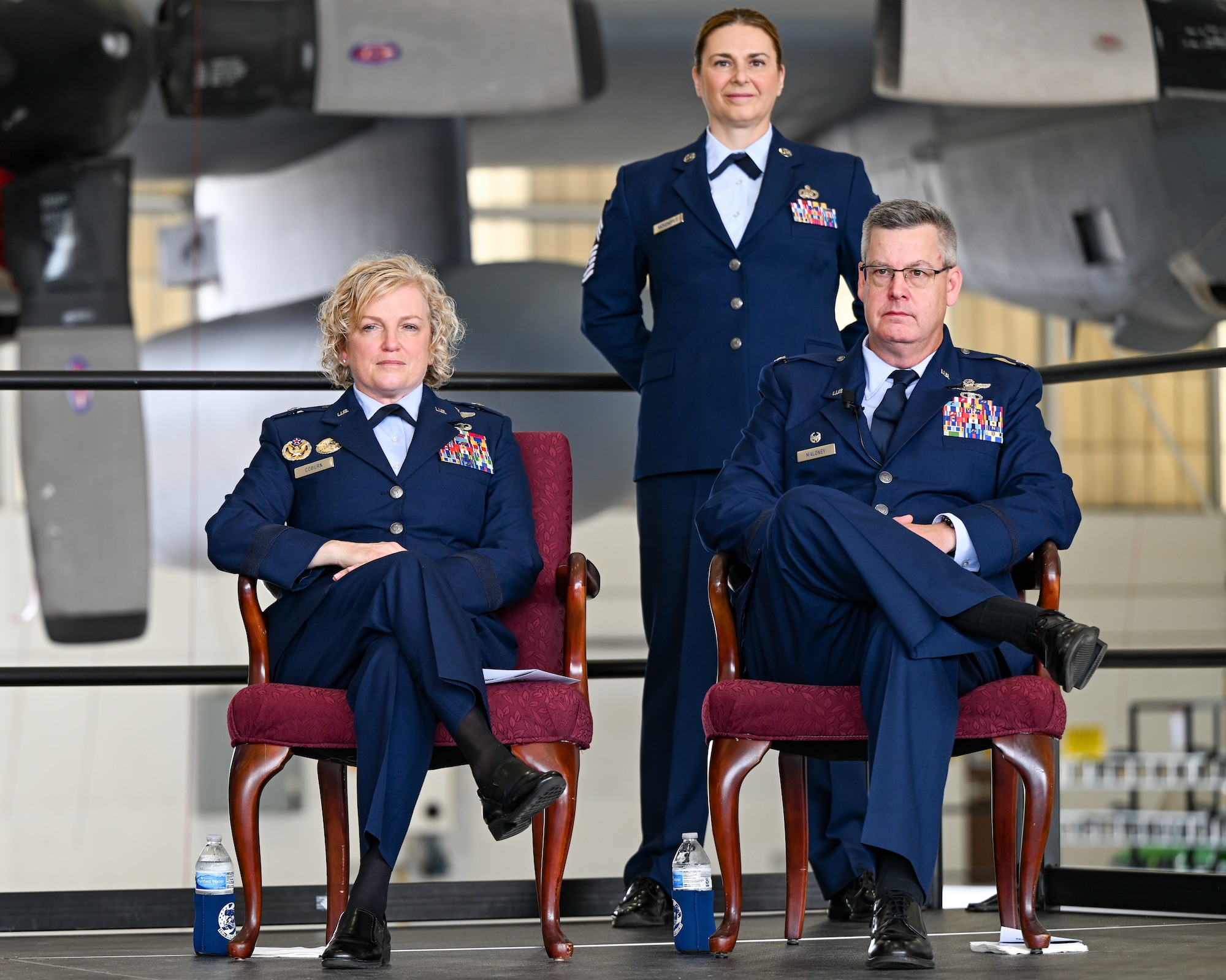 Brig. Gen. Melissa Coburn, 22nd Air Force commander, Chief Master Sgt. Jennifer McKendree, 910th Airlift Wing command chief, and Col. Michael Maloney, 910th Airlift Wing commander, face the audience at the beginning of the wing assumption of command ceremony, July 15, 2023, at Youngstown Air Reserve Station, Ohio.