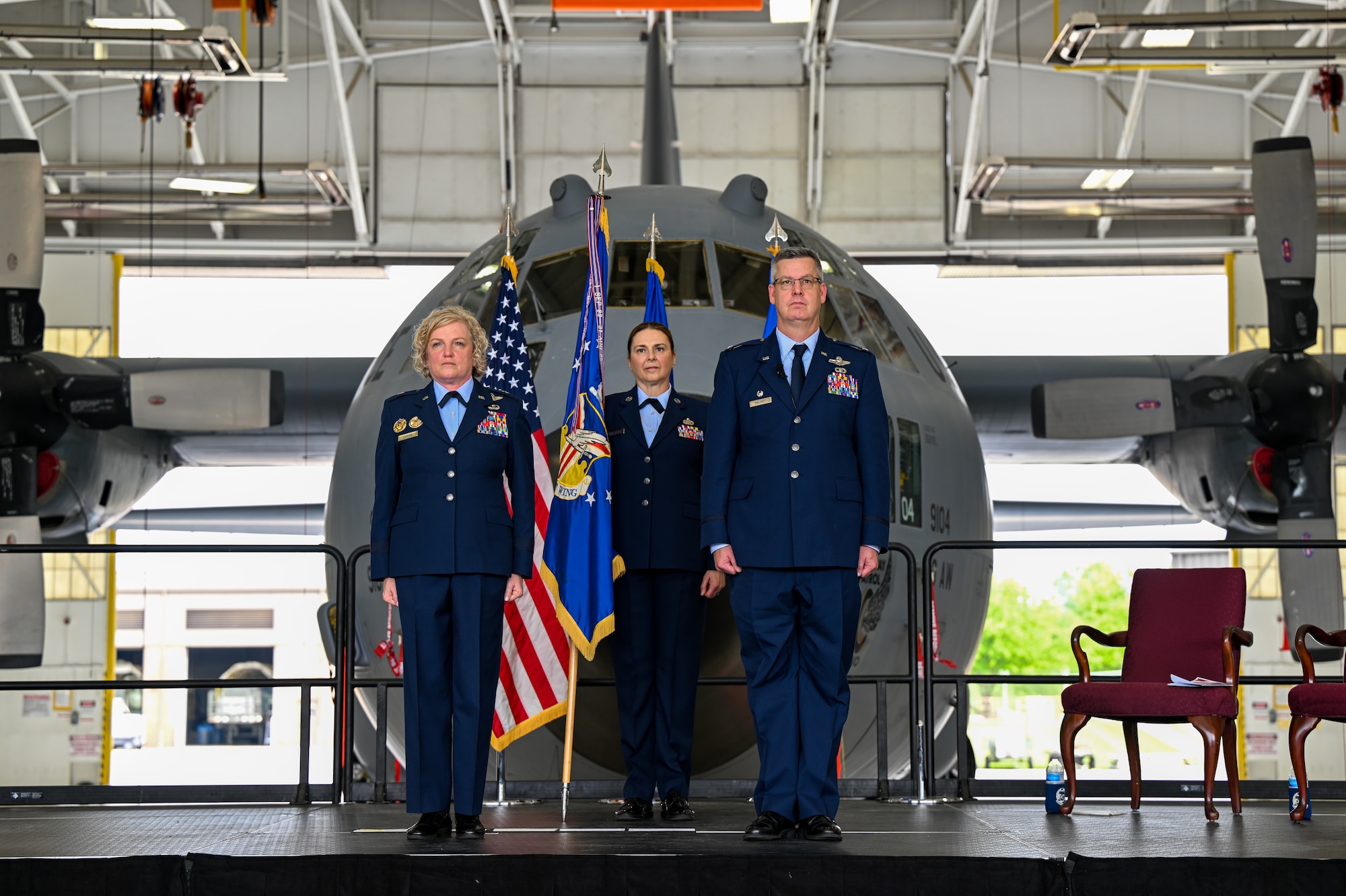 Brig. Gen. Melissa Coburn, 22nd Air Force commander, and Col. Michael Maloney, 910th Airlift Wing commander, prepare to transfer the wing's flag during his assumption of command ceremony, July 15, 2023, at Youngstown Air Reserve Station, Ohio.