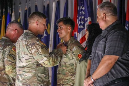 U.S. Army Maj. Gen. Jospeh Ryan, the 25th Infantry Division and U.S. Hawaii commanding general, presents the Soldier's Medal to U.S. Army Spc. Rene Rodriguez, a combat medic assigned to 2nd Battalion, 35th Infantry Regiment, 3rd Infantry Brigade Combat Team, 25th Inf. Div., July 19, 2023, at Schofield Barracks, Hawaii. Rodriguez was presented the award for protecting the life of a Hawaiian woman on Oct. 20, 2022. (U.S. Army photo by 1st Lt. Jordan Balzano)