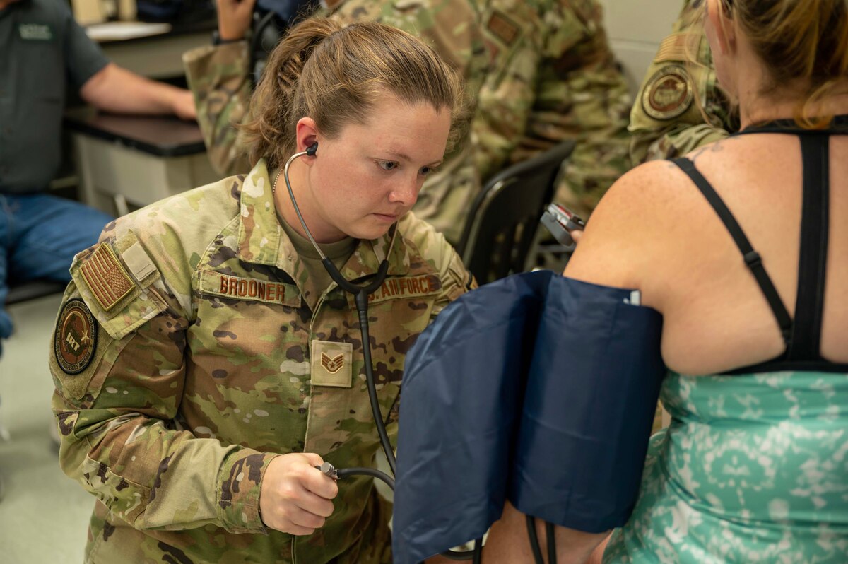 Photo of Airman taking a patients blood pressure.