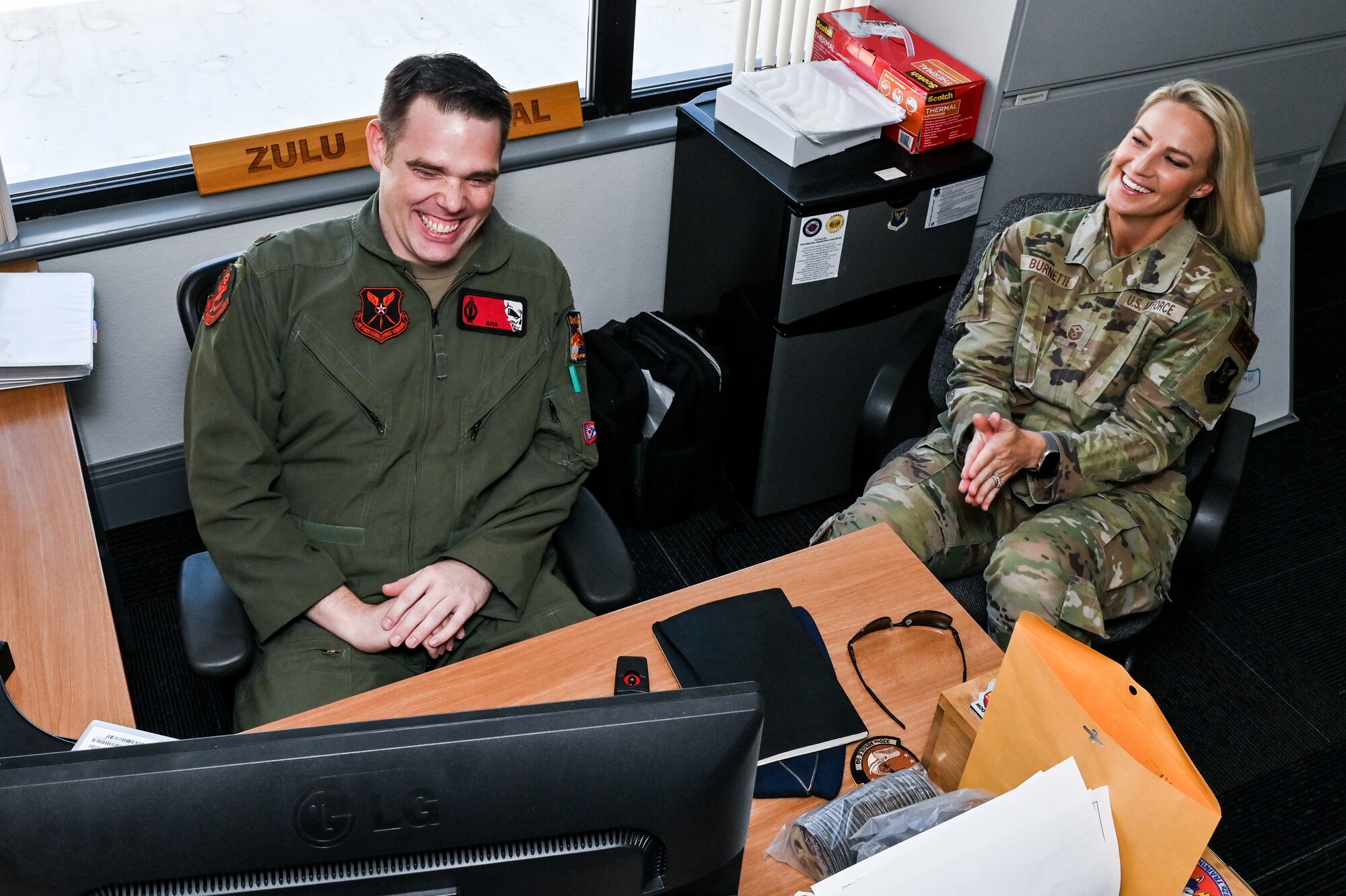 Maj. Ryan Marshall, 320th Missile Squadron assistant director of operations, and Master Sgt. Britni Burnette, 90th Operations Group first sergeant, laugh at a story on F.E. Warren Air Force Base, Wyoming, May 5, 2023. Burnette’s efforts as 90 OG first sergeant earned her the Air Force Global Strike Command’s award for “Outstanding First Sergeant of the Year.” (U.S. Air Force photo by Joseph Coslett Jr.)