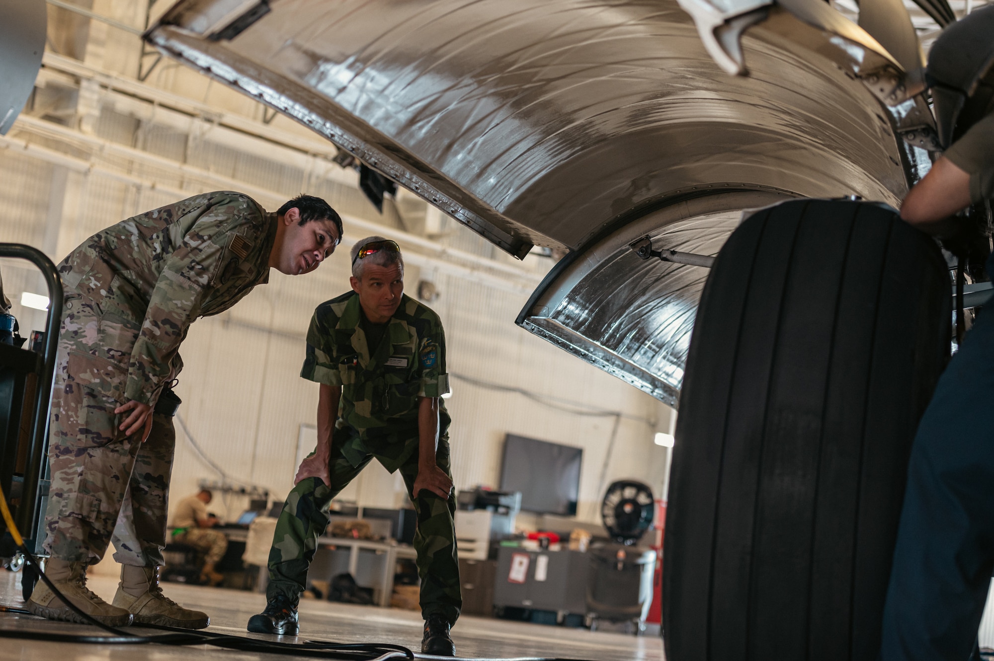 Members of the Swedish Air Force conduct hands-on training during the first C-17 Flying Crew Chief Strategic Airlift Capability Course held for international students at Joint Base McGuire-Dix-Lakehurst, N.J., July 17, 2023. The five-week course is intended to build interoperability between our allies and partners in an effort to bridge knowledge gaps in aircraft maintenance necessary for Rapid Global Mobility and meeting National Defense Strategy requirements. (U.S. Air Force photo by Senior Airman Sergio Avalos)