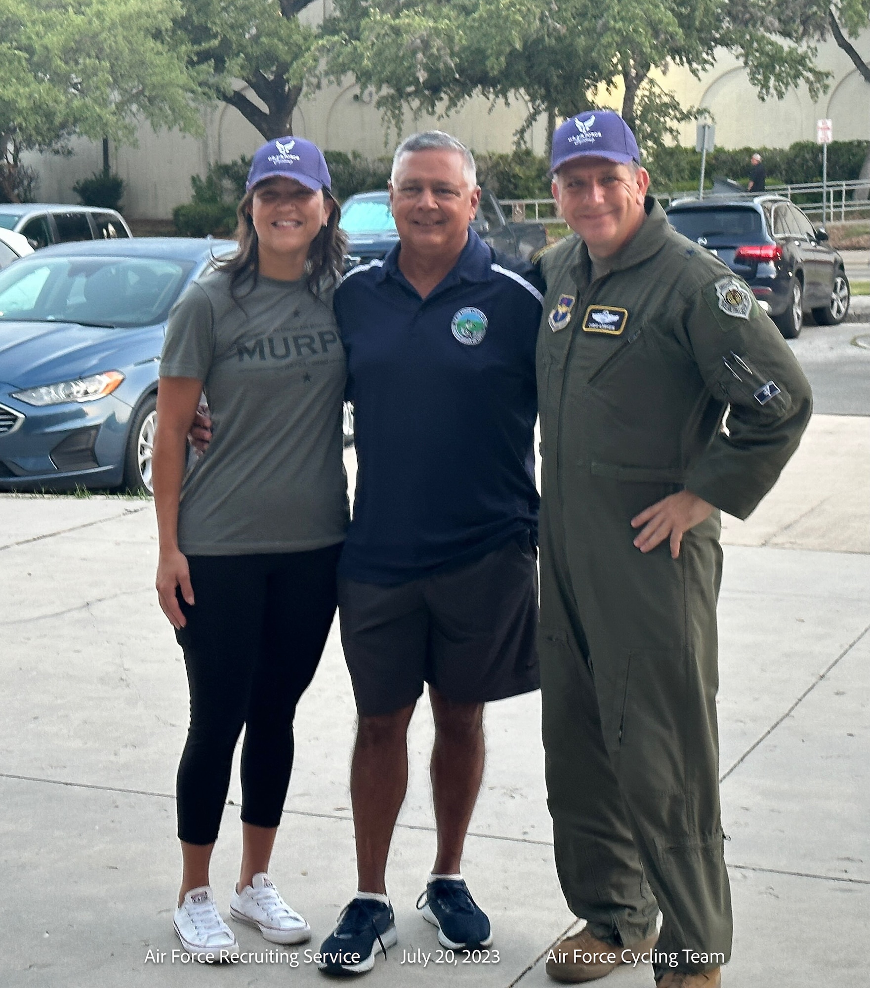 three people pose for a photo