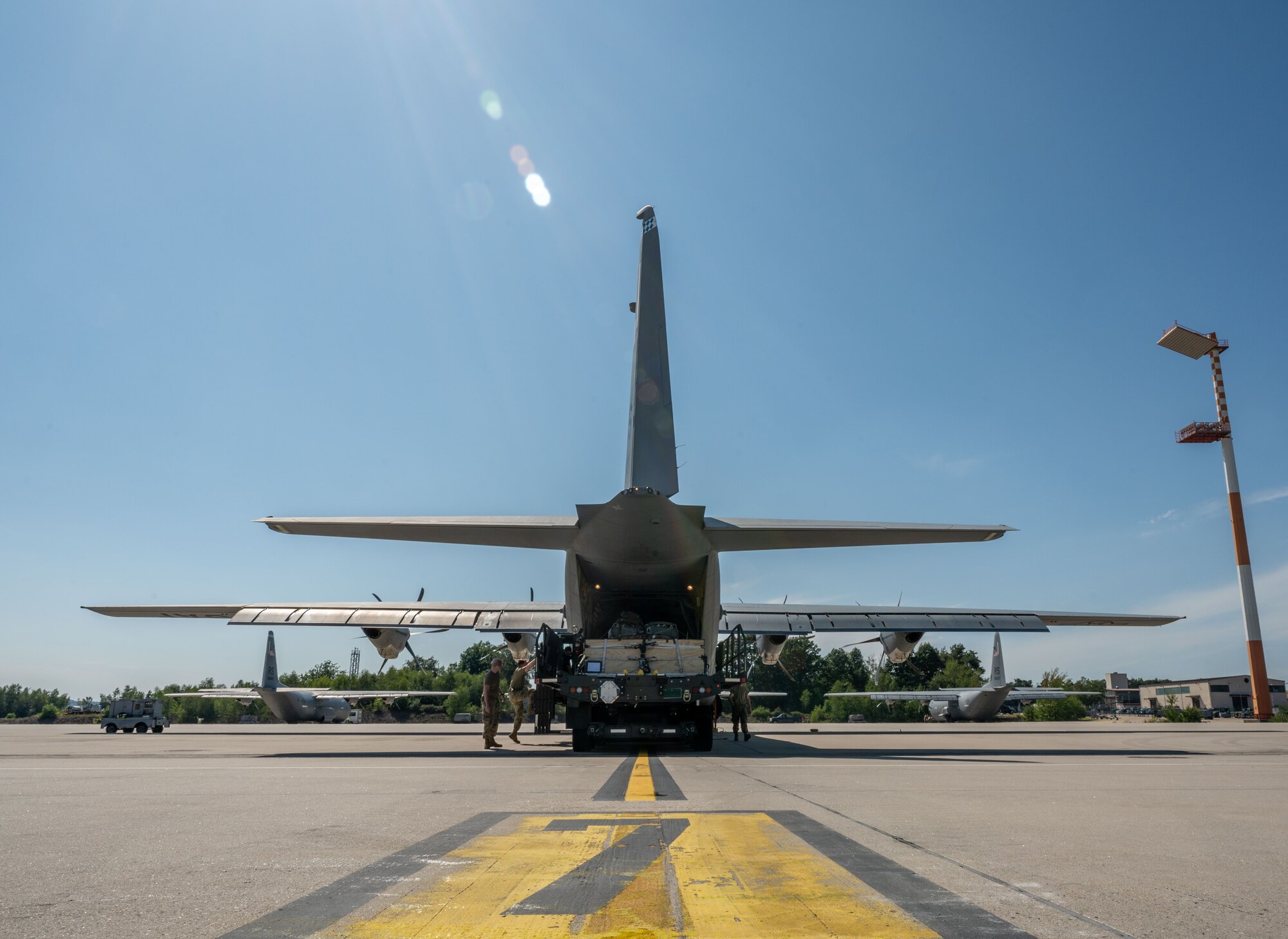 Airmen load cargo on a C-130