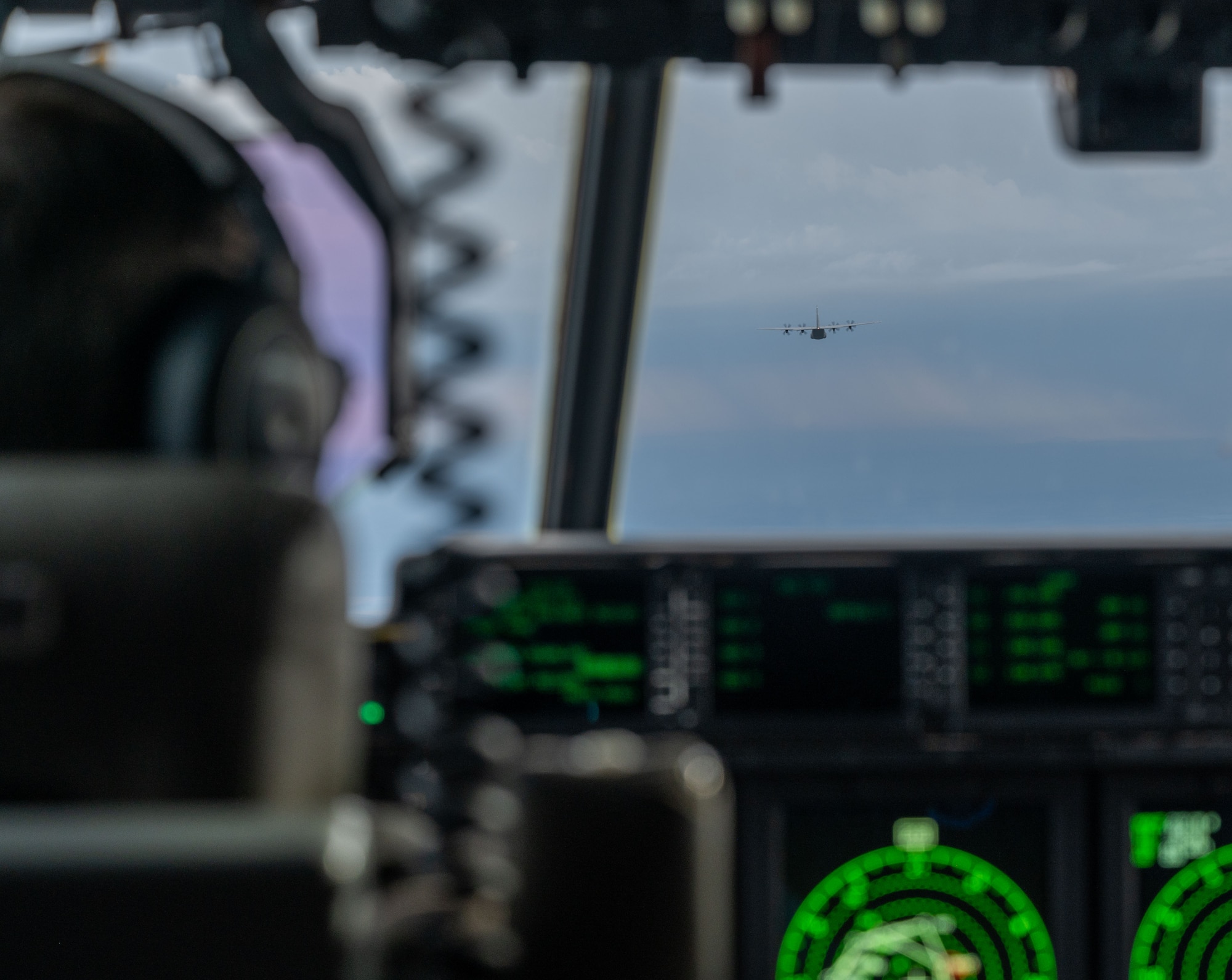 A pilot flies a C-130
