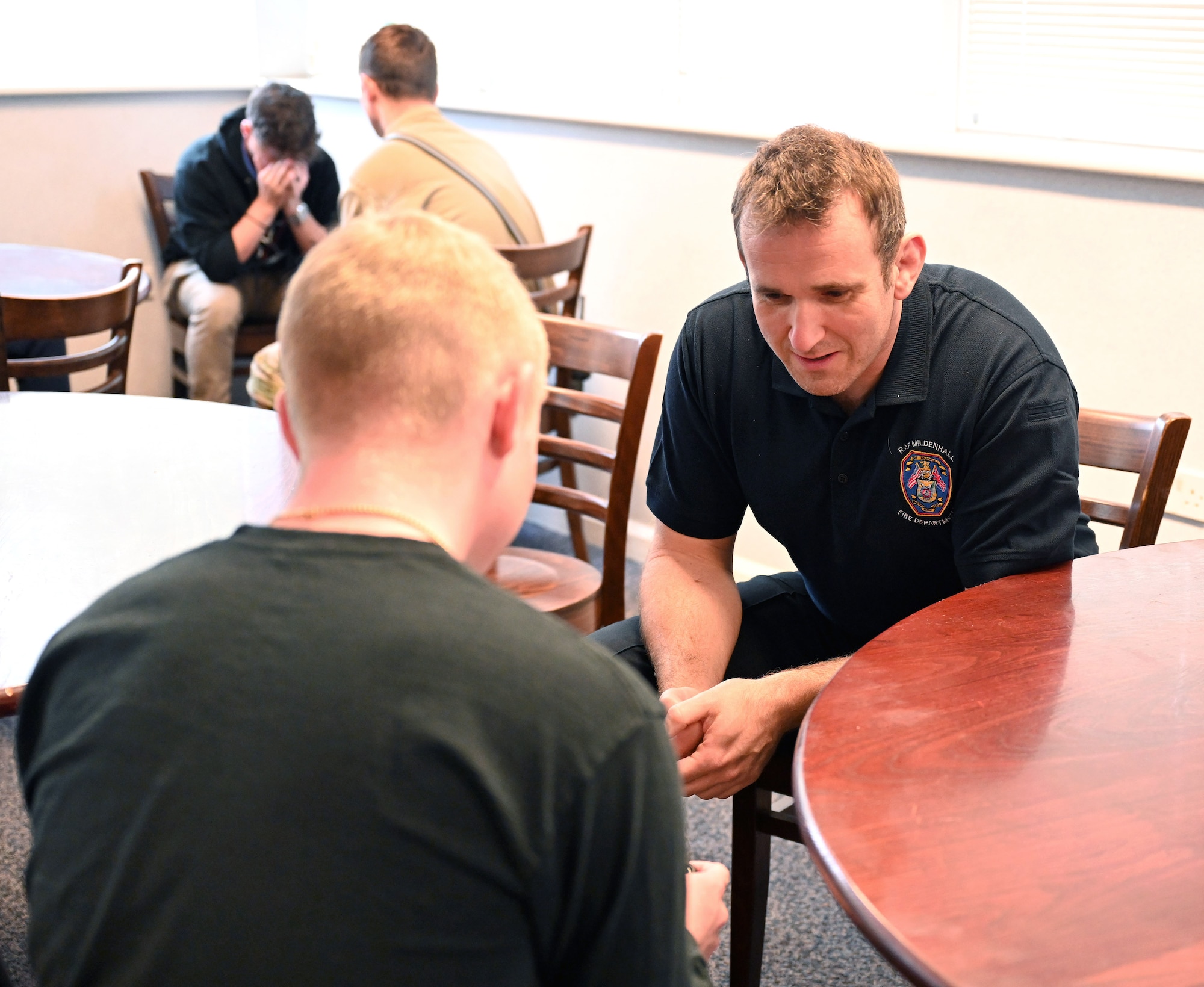 U.S. Air Force Airmen from the 100th Security Forces Squadron, and British civilian firefighters and Airmen from the 100th Civil Engineer Squadron Fire Department, role play during an interactive session as part of a two-day Mental Health First Aider course at Royal Air Force Mildenhall, England, June 27, 2023. Attendees took turns playing the role of both a person dealing with mental health issues and someone listening and helping them talk through their fears and concerns, in a variety of scenarios. First responders from both squadrons attended the training to help provide them the knowledge and confidence to help assist someone experiencing a mental health breakdown, challenge or crisis that they may be responding to or involved with. (U.S. Air Force photo by Karen Abeyasekere)