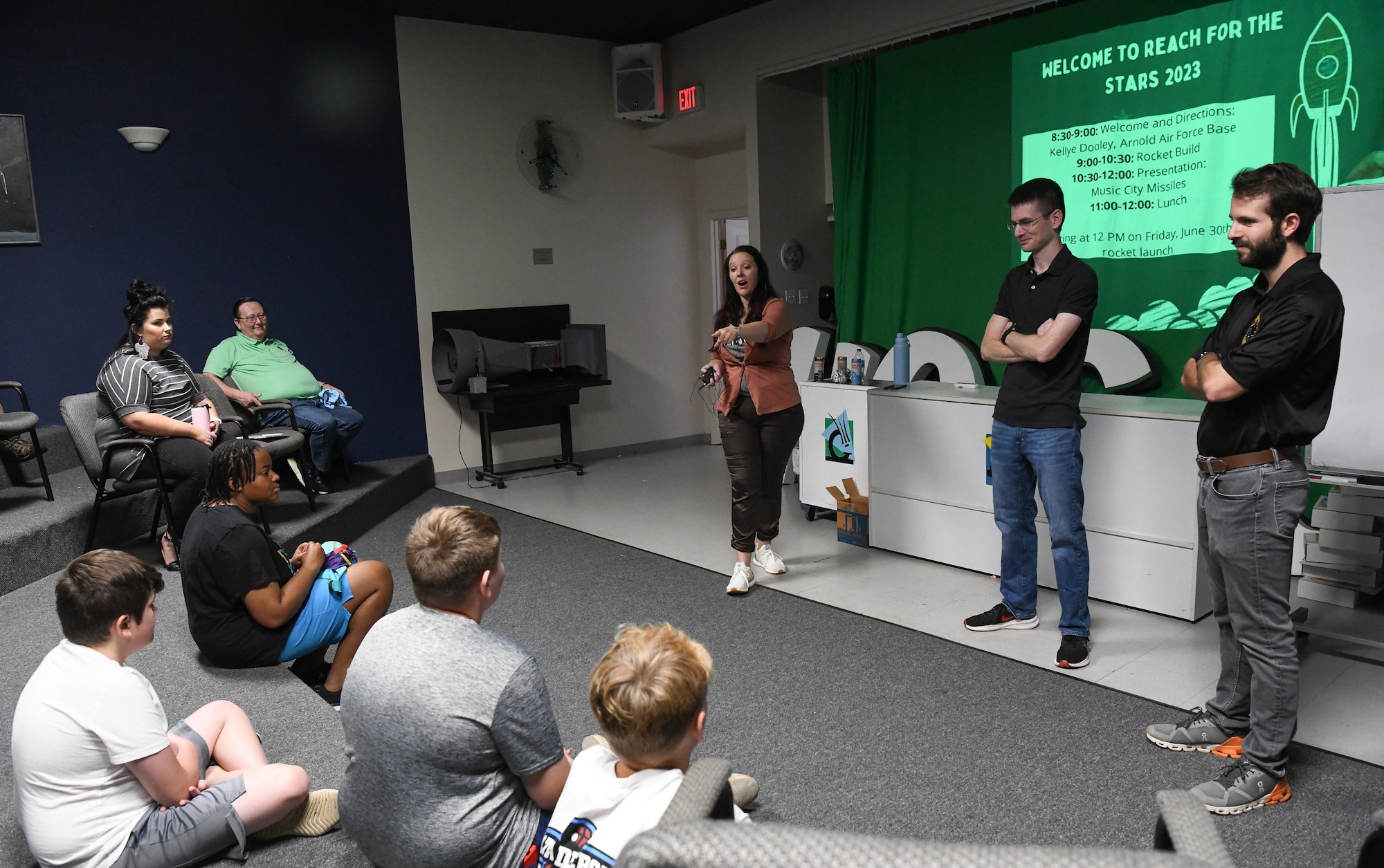 Kellye Dooley, a test engineer with the 718th Test Squadron, calls on a youth during a presentation for the Reach for the Stars event at the Hands-On Science Center in Tullahoma, Tenn., June 23, 2023. Reach for the Stars is a national rocket launch competition. Also pictured are 2nd Lt. Benjamin West, center, and Matt Perenich, both test analysts with the 718 TS, which conducts a variety of testing of space and missile systems. The squadron is part of the 804th Test Group, Arnold Engineering Development Complex, and is headquartered at Arnold Air Force Base, Tenn. (U.S. Air Force photo by Jill Pickett)