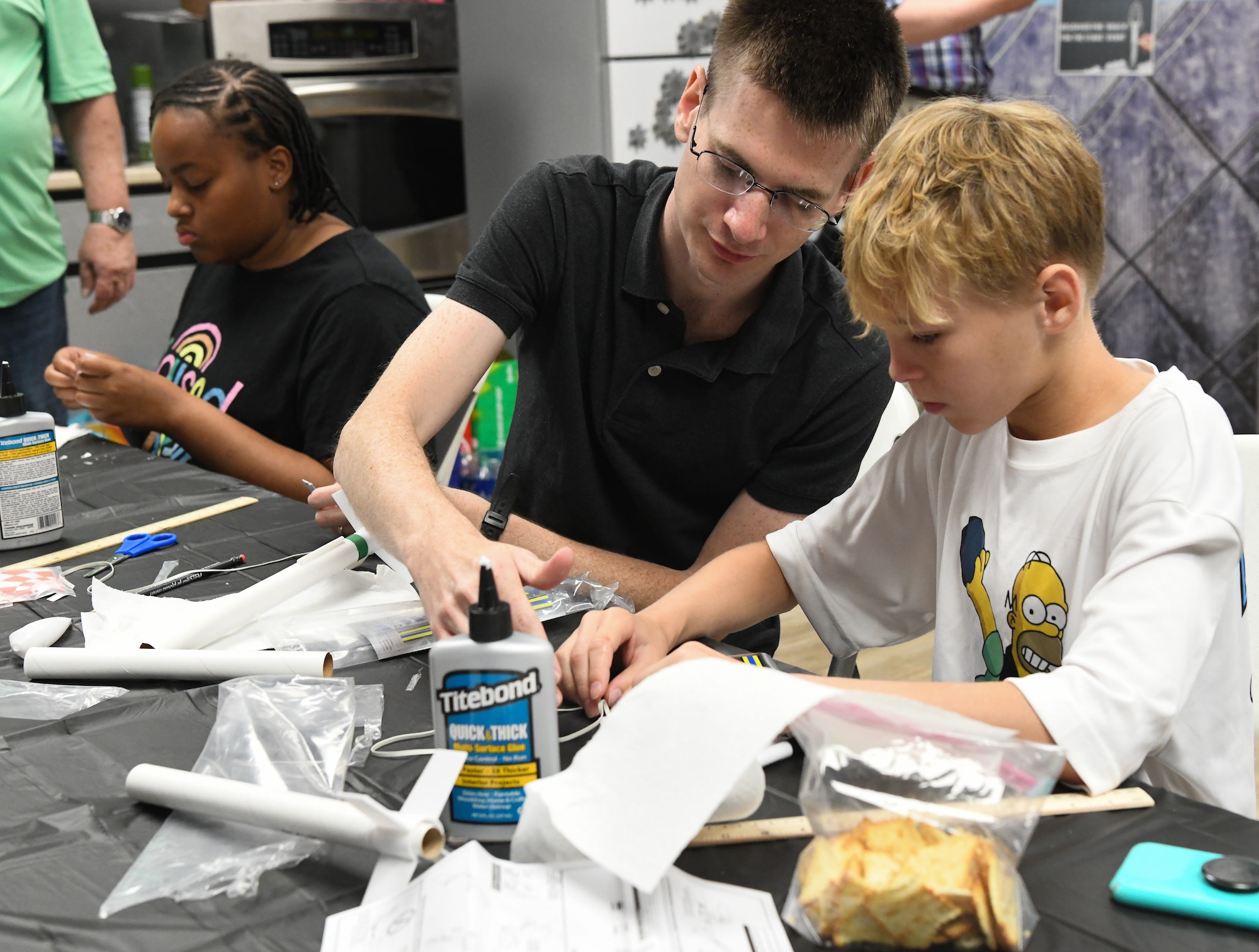 2nd Lt. Benjamin West, with the 718th Test Squadron, helps Gavin Campbell, 11, with the parachute assembly for his model rocket during the Reach for the Stars event at the Hands-On Science Center in Tullahoma, Tenn., June 22, 2023. Reach for the Stars is a national rocket launch competition. The 718 TS is part of the 804th Test Group, Arnold Engineering Development Complex, and is headquartered at Arnold Air Force Base, Tenn. (U.S. Air Force photo by Jill Pickett)