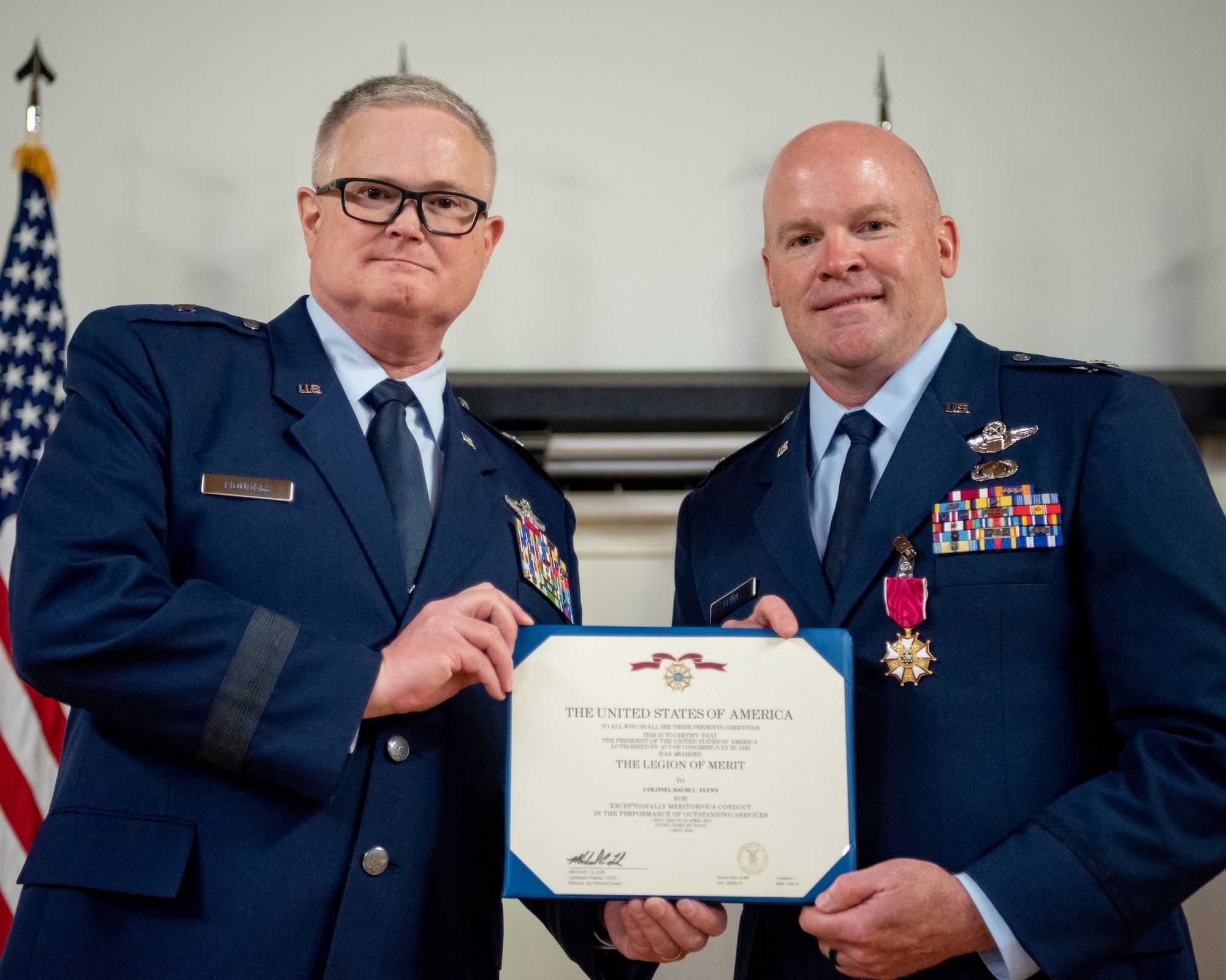 Col. David Flynn (right), outgoing director of air operations for Joint Force Headquarters—Kentucky, receives the Legion of Merit from Brig. Gen. David Mounkes, Kentucky’s assistant adjutant general for Air, during Flynn’s retirement ceremony at the Kentucky Air National Guard Base in Louisville, Ky., May 20, 2023. Flynn is retiring after 28 years of military service. (U.S. Air National Guard photo by Tech. Sgt. Joshua Horton)