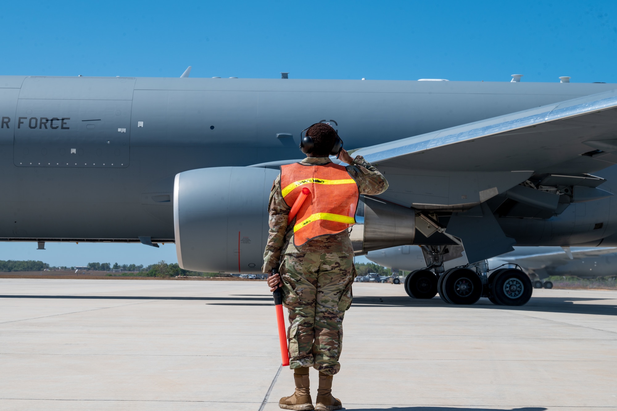 U.S. Airman First Class Ashlynn Sanford, 92nd Air Refueling Wing services Airman, salutes the pilot of a U.S. Air Force KC-46 Pegasus at Royal Australian Air Force Base Darwin, Australia, during Mobility Guardian 23, July 12, 2023. MG23 is a mobility exercise held across a 3,000-mile area intended to deepen interoperability with U.S. allies and partners, bolstering the collective ability to support a free and open Indo-Pacific area. (U.S. Air Force photo by 1st Lt. Ariana Wilkinson)