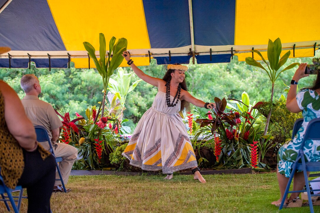 A hula dancer performs in ceremonial dress.