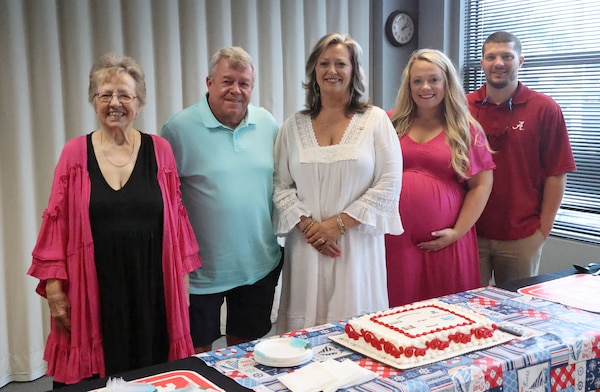 Rhonda Cole, U.S. Army Corps of Engineers, Mobile District CIO/G6 operations officer, center, poses with her family at her retirement ceremony at the Mobile District annex building in Mobile, Alabama, July 14, 2023. Cole, who retired after 40 years of service in the federal government, said her family has been her rock throughout her career. (U.S. Army photo by Chuck Walker)