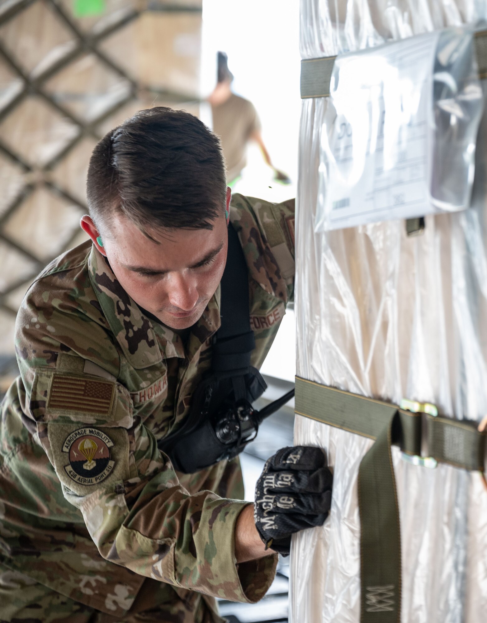 Staff Sgt. James Thomas, 436th Aerial Port Squadron ramp services craftsman, pushes palletized cargo, bound for Romania, onto a C-5M Super Galaxy during a foreign military sales mission at Dover Air Force Base, Delaware, June 27, 2023. The partnership between the United States and Romania is rooted in a shared commitment to democratic values, including the rule of law, open markets, respect for and the promotion of human rights. (U.S. Air Force photo by Senior Airman Cydney Lee)