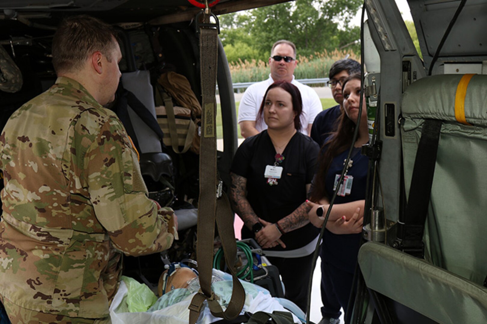 Aurora BayCare Medical Center professionals discuss emergency room procedures with Soldiers from the medevac assets of the Wisconsin Army National Guard’s 1st Battalion, 147th Aviation Regiment during a June 22 event.
