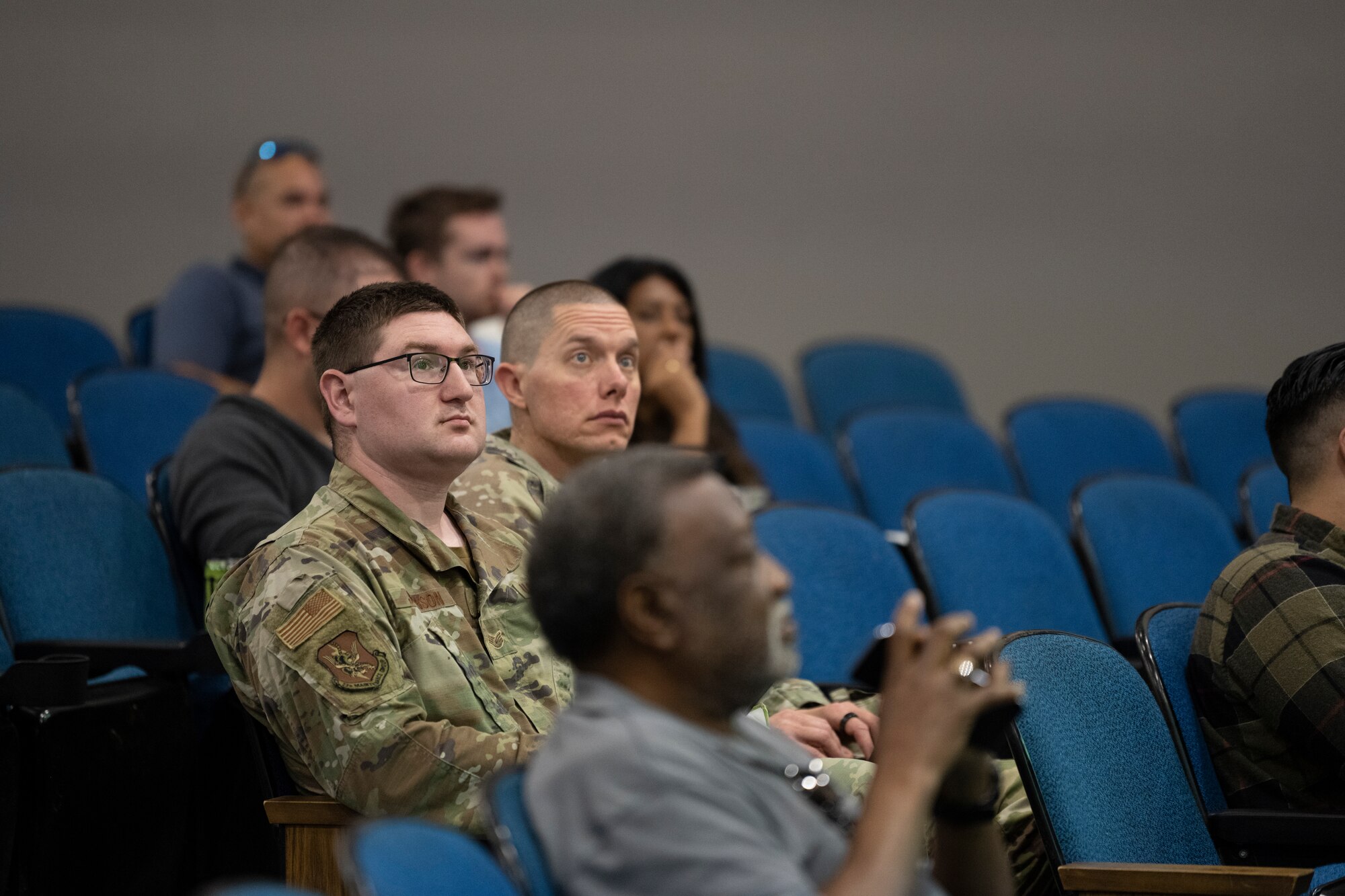 A photo of people sitting in auditorium seats