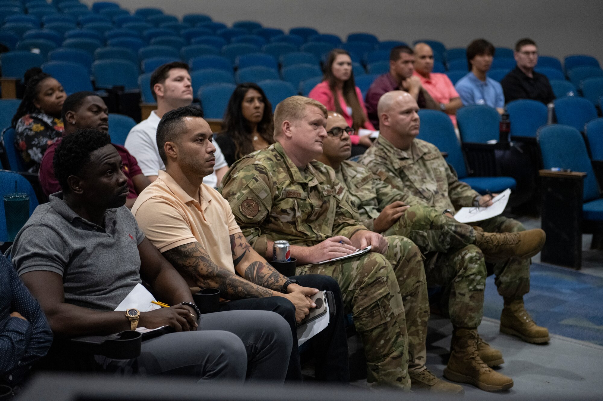 A photo of people sitting in auditorium seats