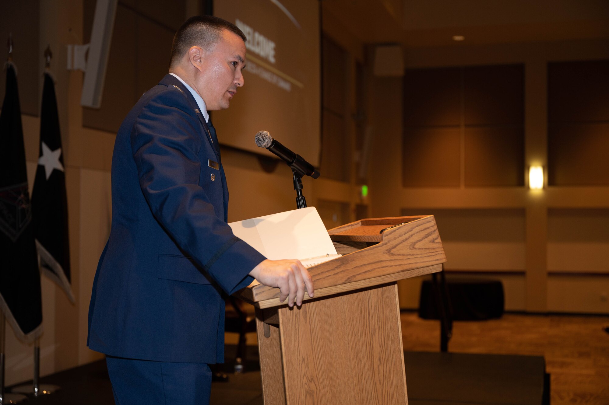 A man speaks at a podium.