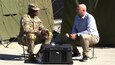 Dr. Nathan Fisher, a senior scientist, sits with U.S. Army Sgt. 1st Class Timothy Hughes, the public affairs chief for U.S. Army Pacific’s 18th Medical Command, which is part of the Australian Defence Force and U.S. Combined Joint Theater Medical Component, to discuss Wearable Pilot Program technology being tested in the field during Exercise Talisman Sabre 2023 in Brisbane, Australia, July 19, 2023. The Combined Joint Theater Medical Component coordinates and synchronizes health service and support across the Australian continent, which is nearly the size of the mainland of the U.S. Talisman Sabre is the largest bilateral military exercise between Australia and the United States advancing a free and open Indo-Pacific by strengthening relationships and interoperability among key allies and enhancing our collective capabilities to respond to a wide array of potential security concerns. (U.S. Army photo by Sgt. 1st Class Timothy Hughes/Released)