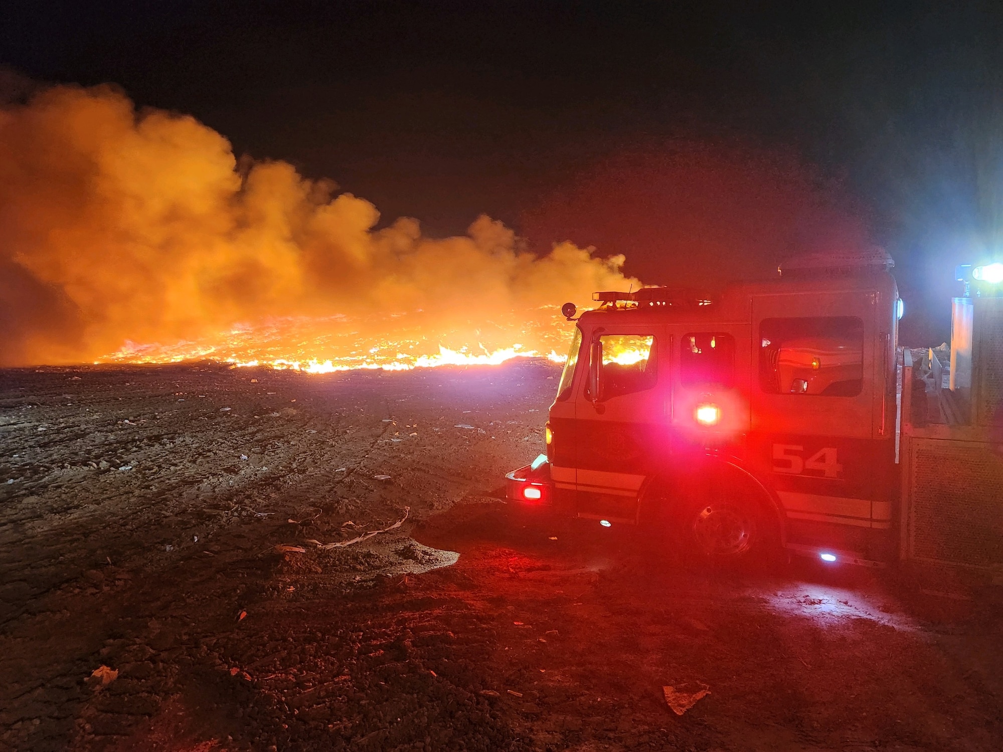 A Phoenix Fire Department firetruck responds to a 3-acre fire at the Glendale Municipal Landfill, around 9 p.m., July 19, 2023, in Glendale, Arizona.