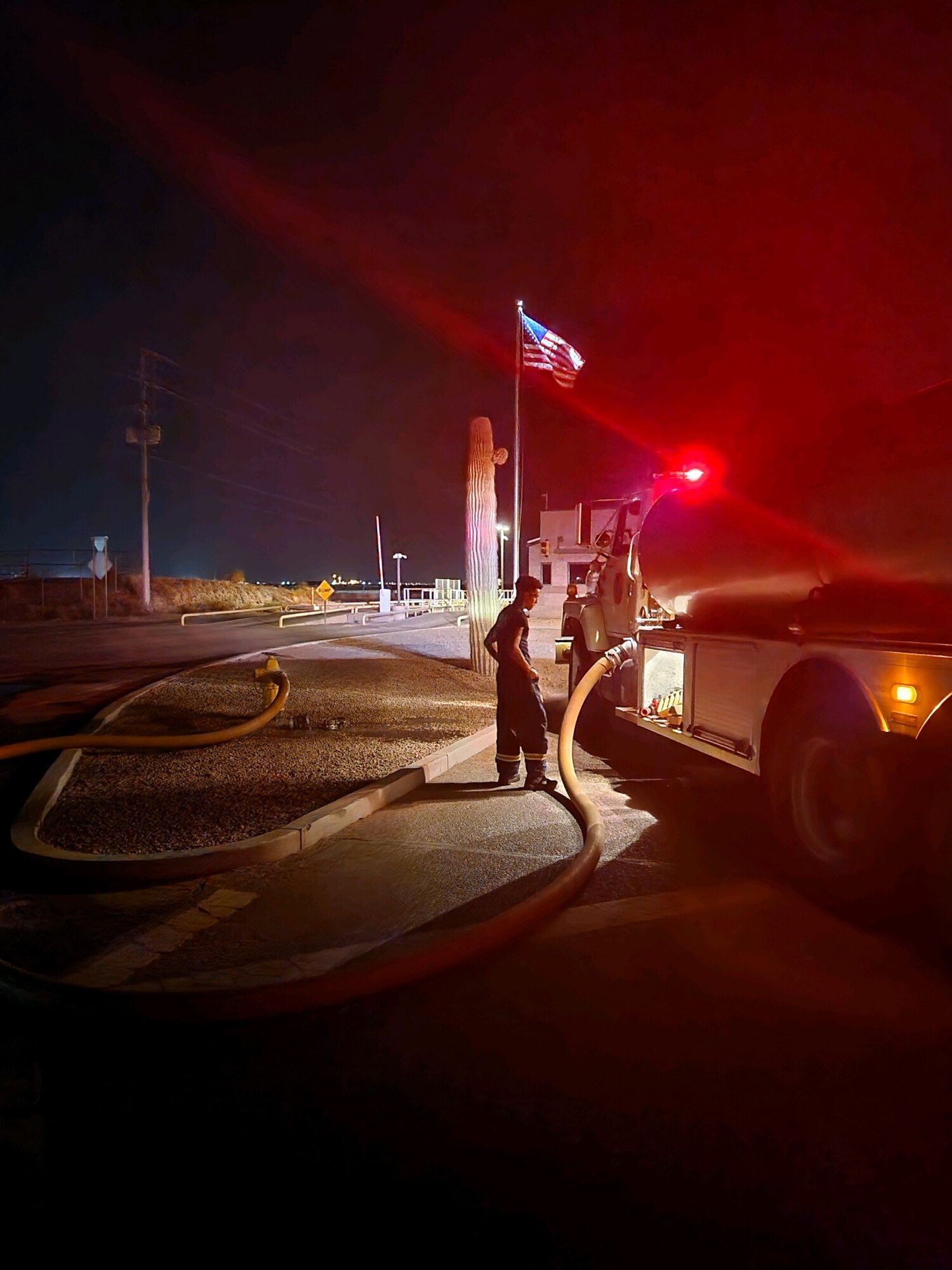 A 56th Civil Engineer Squadron firefighter adjusts water pressure on a water tanker in response to a 3-acre fire at the Glendale Municipal Landfill, around 9 p.m., July 19, 2023, in Glendale, Arizona.