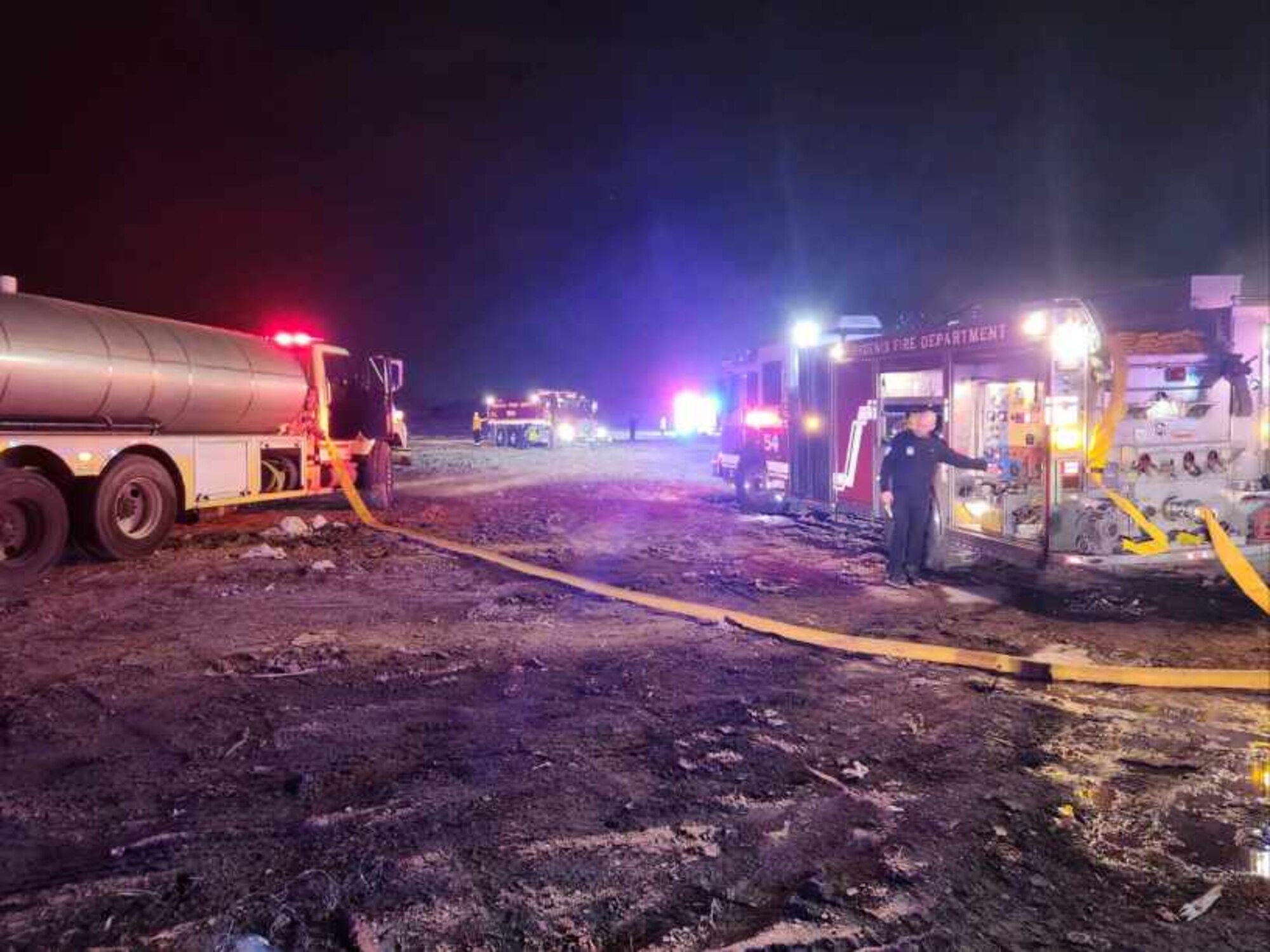 A Phoenix Fire Department firetruck (left) and a 56th Civil Engineer Squadron Fire Department water tanker (right) respond to a 3-acre fire at the Glendale Municipal Landfill, around 9 p.m., July 19, 2023, in Glendale, Arizona.