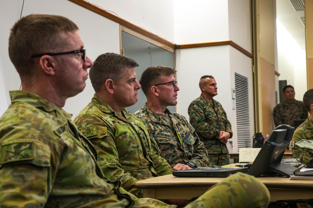U.S. Marines with 1st Marine Division and members of the Australian army receive a staff brief from members of 1st MARDIV during Exercise Talisman Sabre 23 at Lavarack Barracks in Townsville, Australia, July 20, 2023. Talisman Sabre is the largest bilateral military exercise between Australia and the United States advancing a free and open Indo-Pacific by strengthening relationships and interoperability among key Allies and enhancing our collective capabilities to respond to a wide array of potential security concerns. (U.S. Marine Corps photo by Cpl. Emeline Molla)